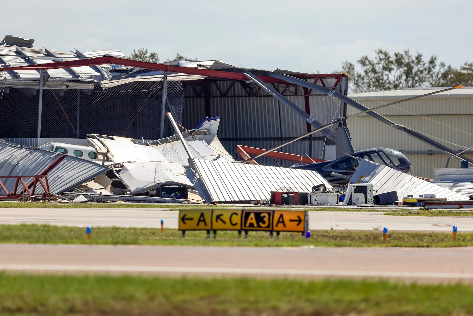 Hangars at Albert Whitted Airport were damaged by winds from Hurricane Milton on Thursday, Oct. 10, 2024, in St. Petersburg, Fla. (AP Photo/Mike Carlson)