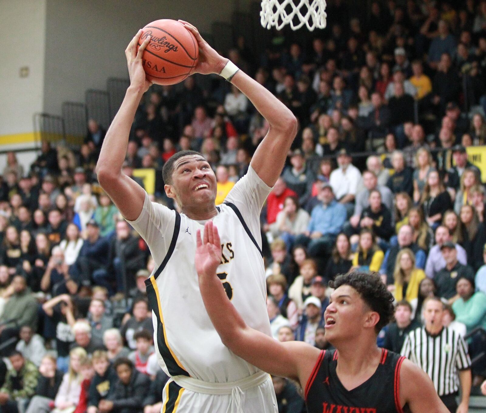 Mo Njie of Centerville elivates over Elijah Brown of Wayne. Wayne defeated host Centerville 52-50 in a GWOC boys high school basketball game on Friday, Dec. 13, 2019. MARC PENDLETON / STAFF