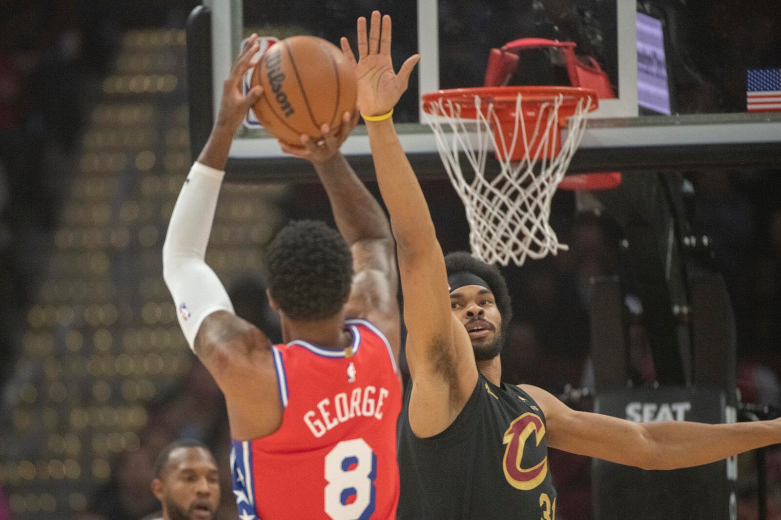 Philadelphia 76ers' Paul George (8) shoots as Cleveland Cavaliers' Jarrett Allen, right, defends during the first half of an NBA basketball game in Cleveland, Saturday Dec. 21, 2024. (AP Photo/Phil Long)