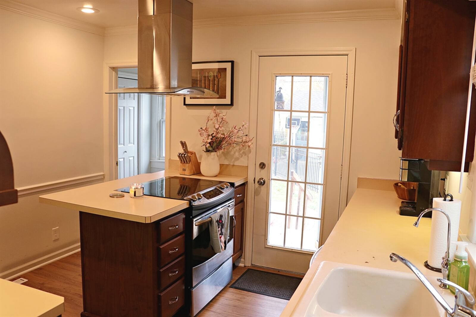 A window is above the double sink in the kitchen; and a large peninsula counter has an extended counter for breakfast seating.  