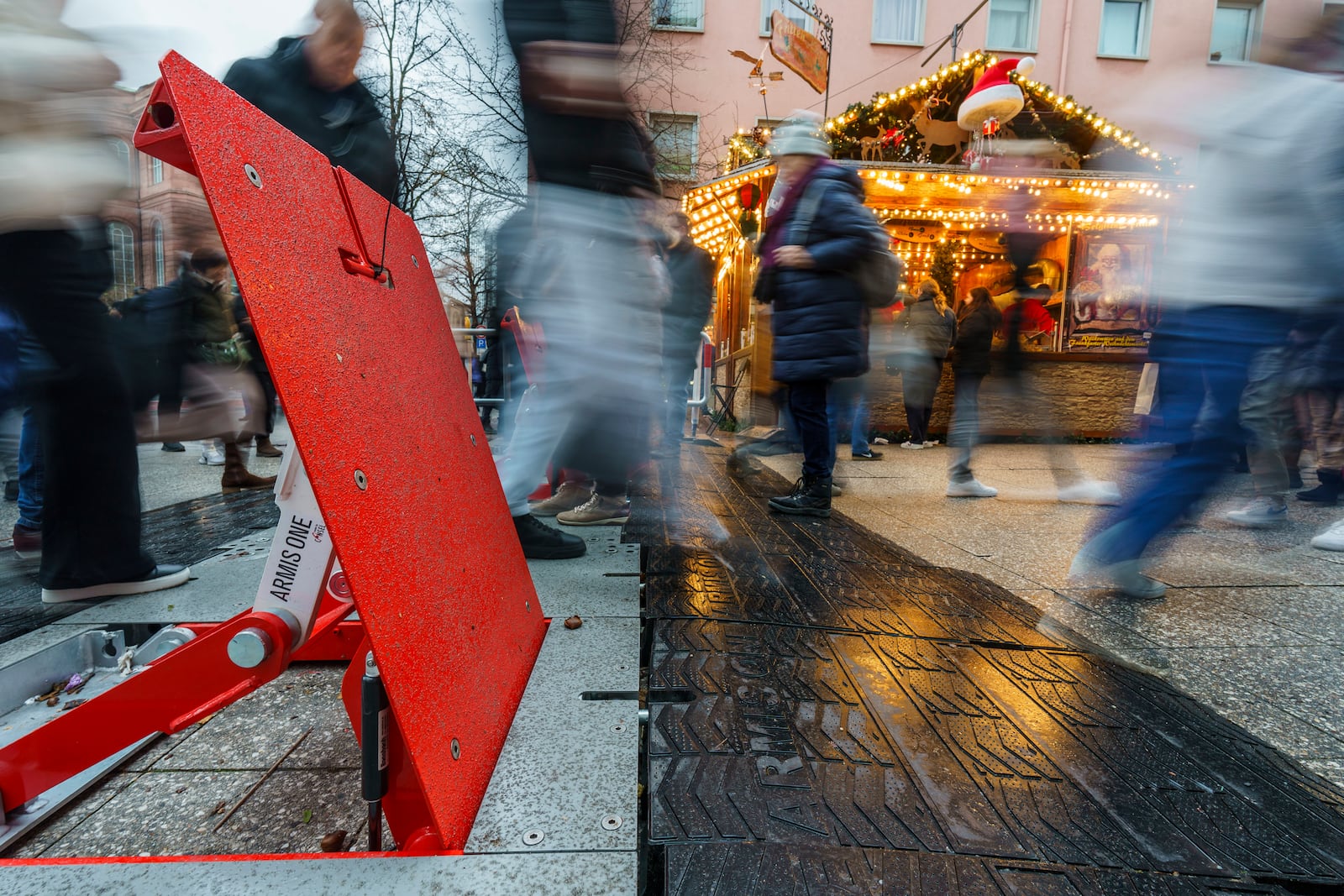 Visitors to the Frankfurt Christmas market pass through security barriers in Frankfurt, Germany, Saturday, Dec. 21, 2024. (Andreas Arnold/dpa via AP)