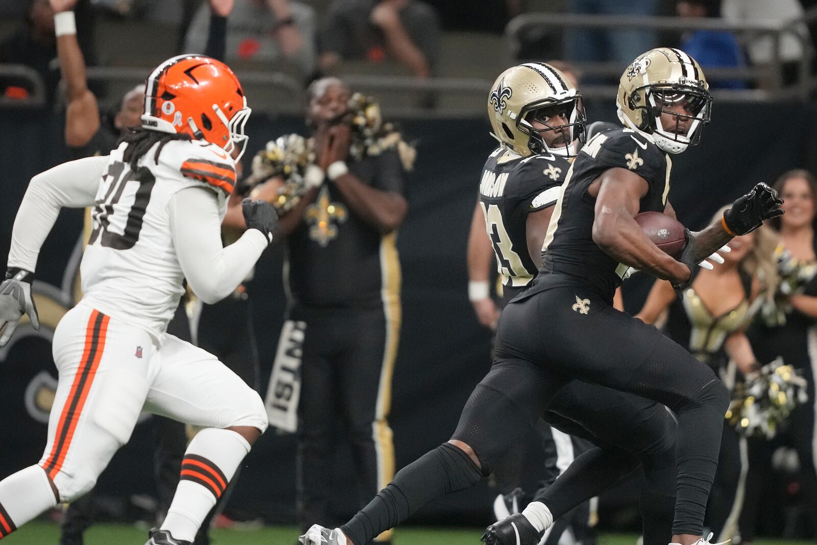 New Orleans Saints wide receiver Marquez Valdes-Scantling looks over his shoulder at Cleveland Browns linebacker Devin Bush (30) as he scores in the first half of an NFL football game in New Orleans, Sunday, Nov. 17, 2024. (AP Photo/Gerald Herbert)