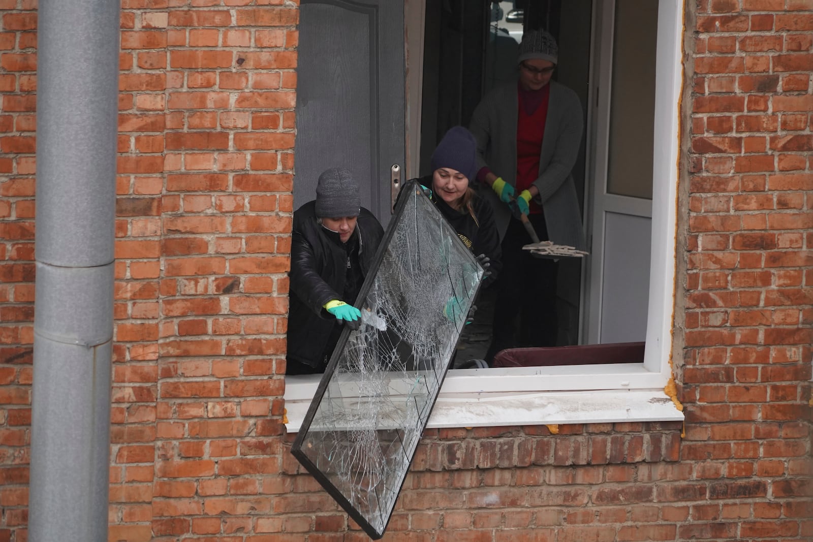 Medical workers clear the rubble in a hospital damaged by a Russian strike, in Kharkiv, Ukraine, Saturday, March 1, 2025. (AP Photo/Andrii Marienko)