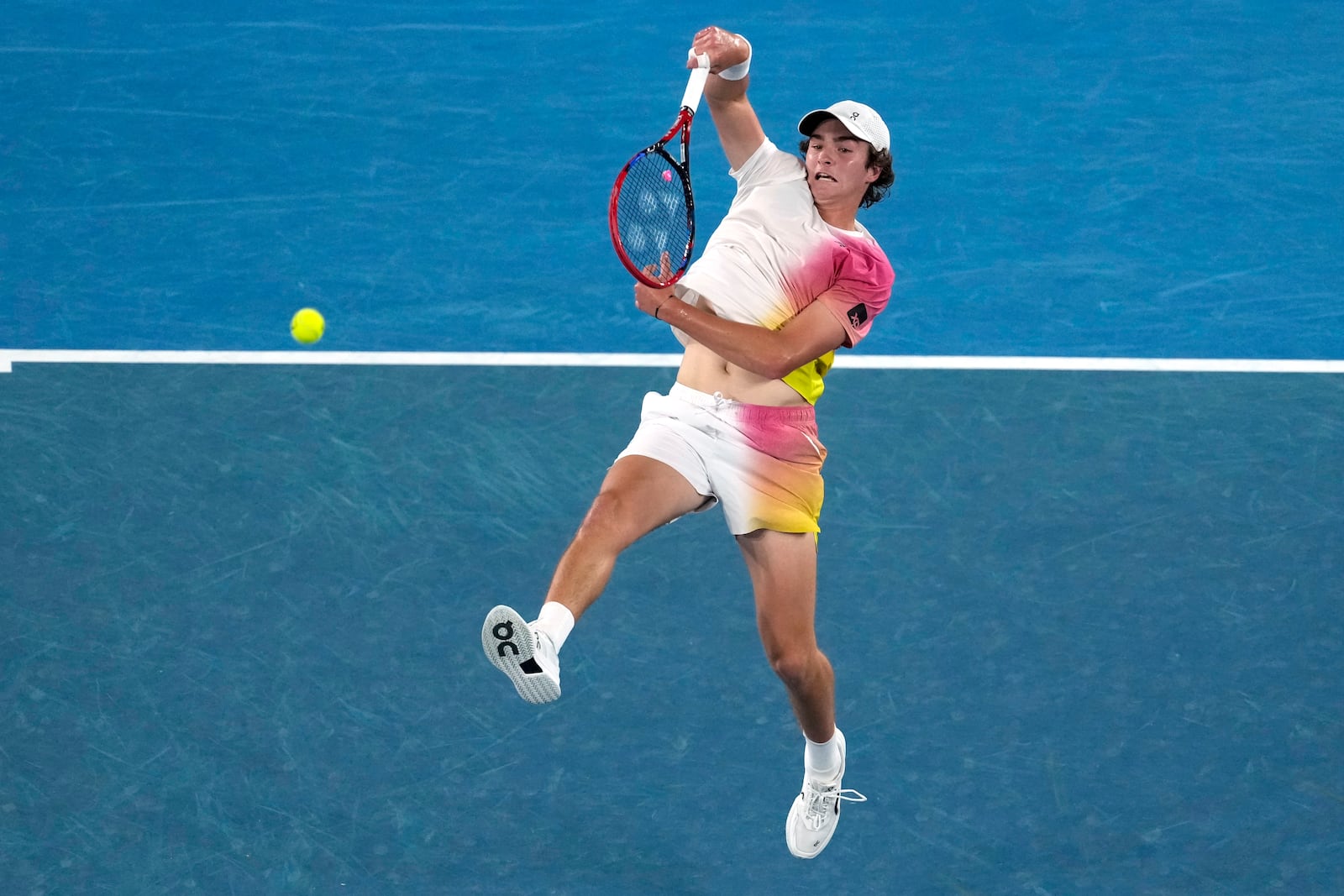 Joao Fonseca of Brazil plays a forehand return to Andrey Rublev of Russia during their first round match at the Australian Open tennis championship in Melbourne, Australia, Tuesday, Jan. 14, 2025. (AP Photo/Asanka Brendon Ratnayake)