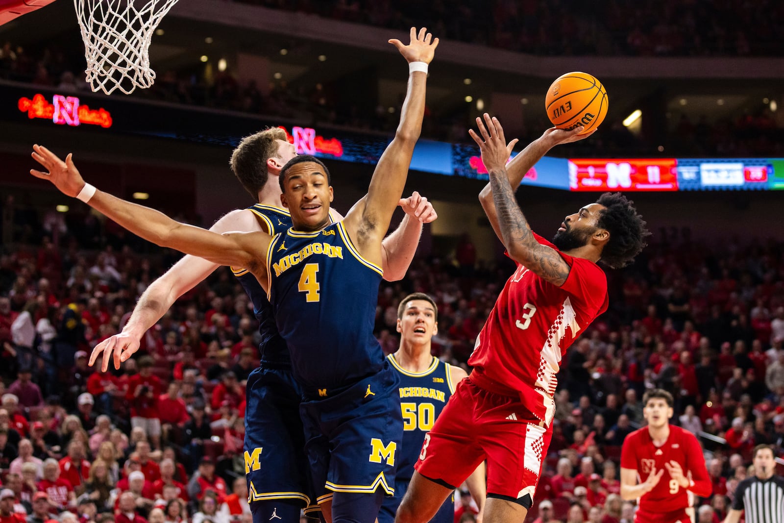 Nebraska guard Brice Williams shoots against Michigan guard Nimari Burnett (4) during the first half of an NCAA college basketball game, Monday, Feb. 24, 2025, in Lincoln, Neb. (AP Photo/Bonnie Ryan)