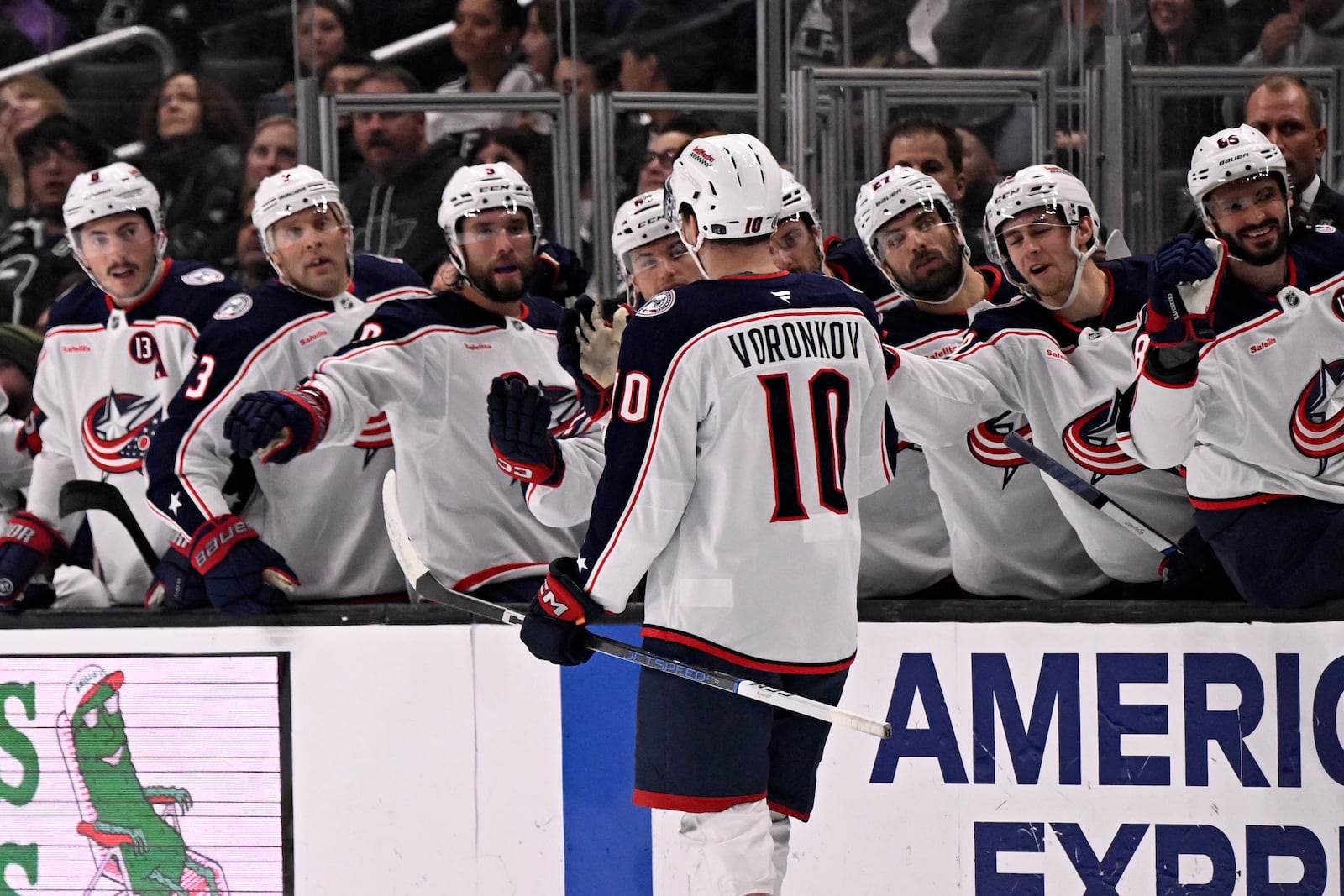 Columbus Blue Jackets left wing Dmitri Voronkov (10) celebrates after scoring a goal against the Los Angeles Kings with teammates on the bench during the first period of an NHL hockey game in Los Angeles, Saturday, Nov. 9, 2024. (AP Photo/Alex Gallardo)