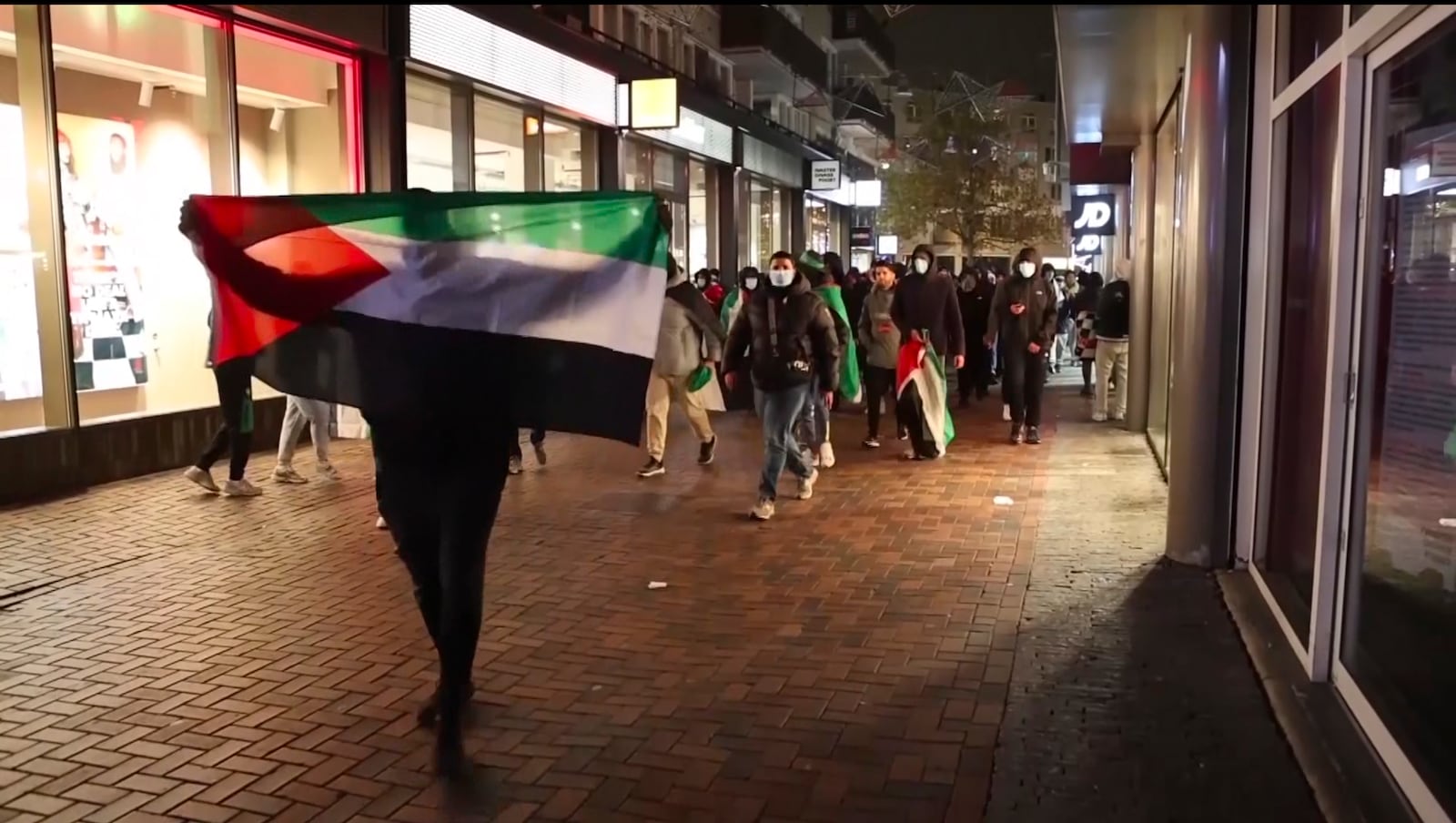 In this image taken from video, pro-Palestinian supporters march with Palestinian flags near the Ajax stadium in Amsterdam, the Netherlands, Thursday, Nov. 7, 2024. (AP Photo InterVision)