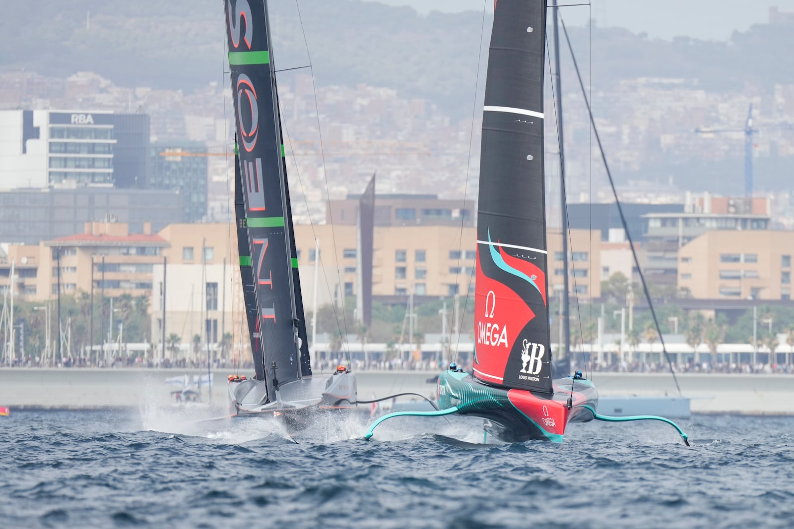 Ineos Britannia and Emirates Team New Zealand race during the Louis Vuitton 37th America's Cup Day 2 race in Barcelona, Spain, Sunday, Oct. 13, 2024. (AP Photo/Bernat Armangue)