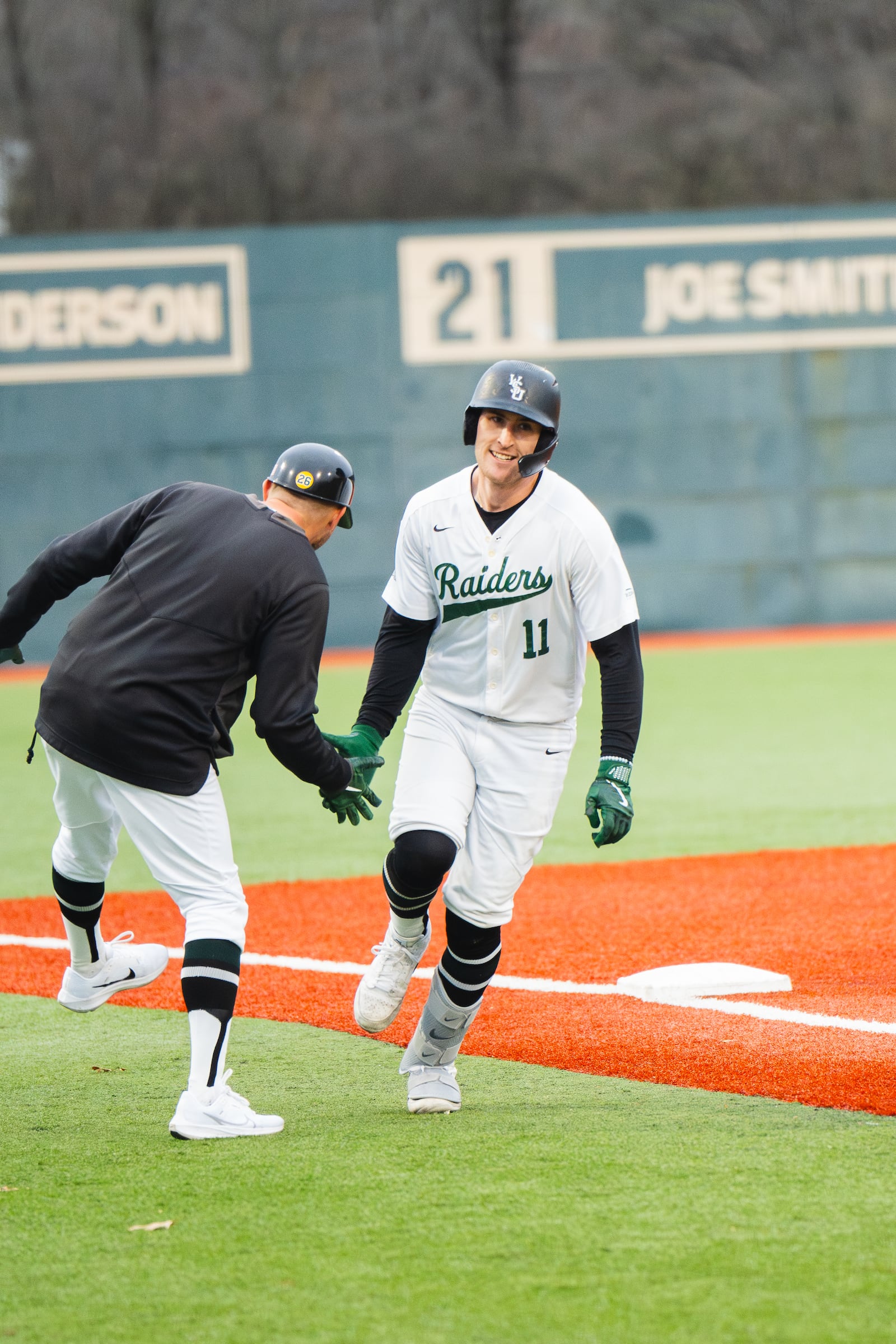 Wright State's Sammy Sass (11) is congratulated after hitting a home run earlier this season. Sass cracked four home runs on Tuesday in the Raiders' 22-21 loss to Miami. Wright State Athletics photo