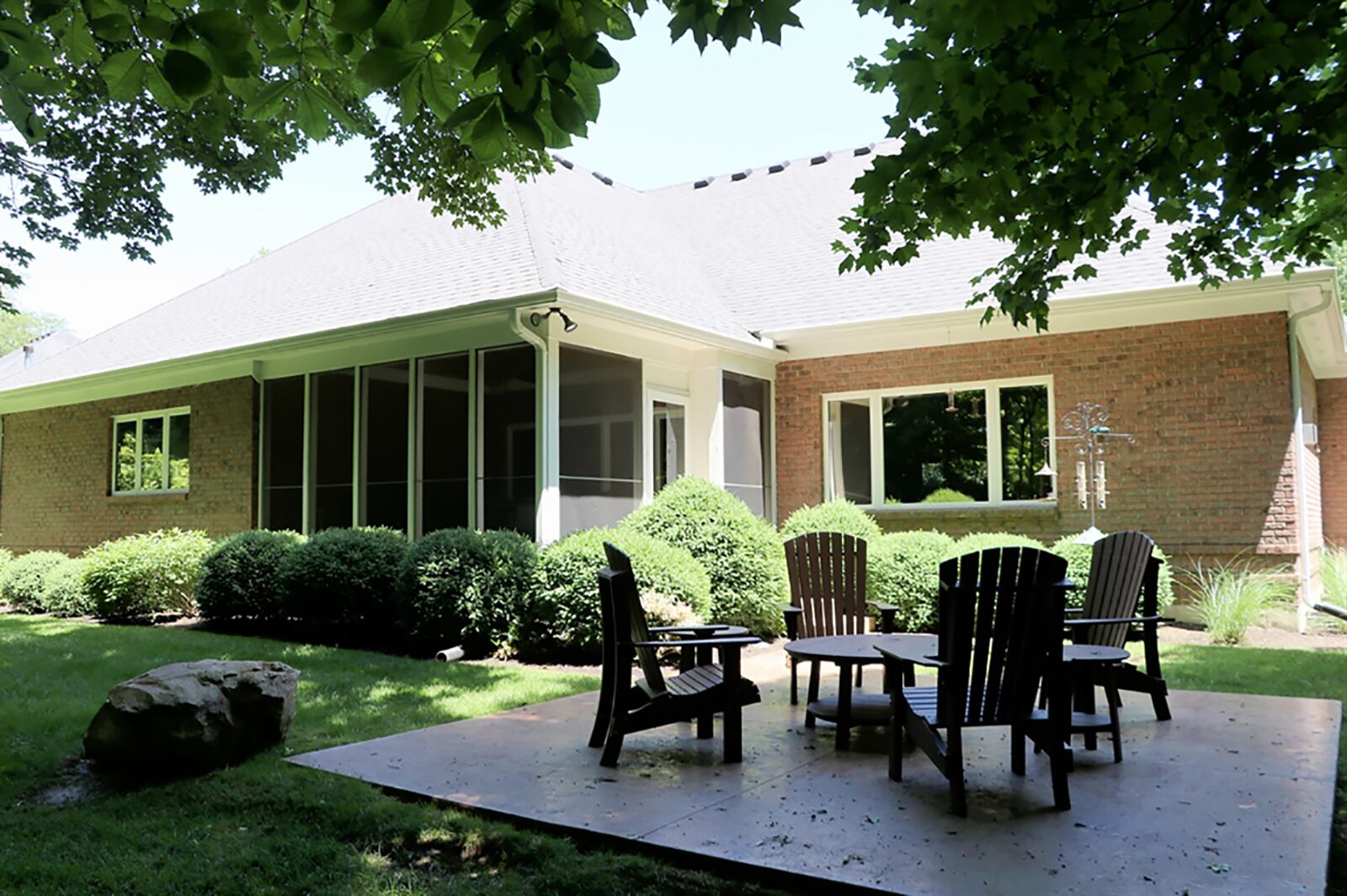 The ranch is nestled among the nearly 1-acre, park-like property with a stamped-concrete rear patio. CONTRIBUTED PHOTO BY KATHY TYLER