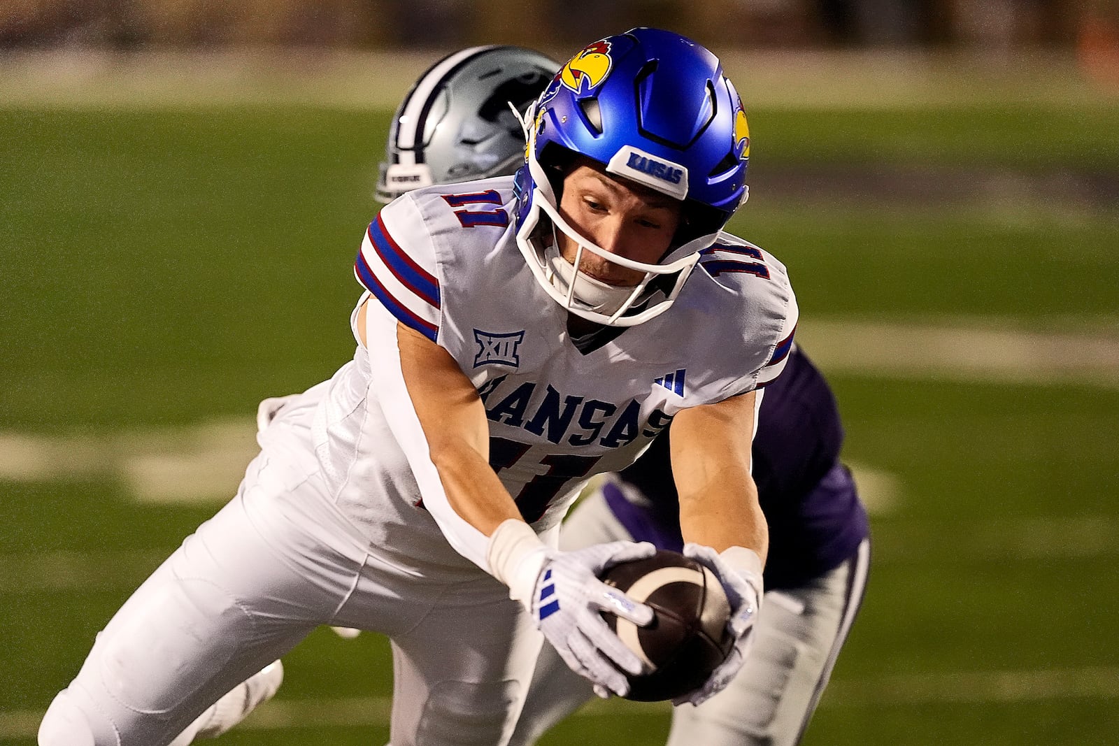 Kansas wide receiver Luke Grimm (11) gets past Kansas State cornerback Keenan Garber to score a touchdown during the first half of an NCAA college football game Saturday, Oct. 26, 2024, in Manhattan, Kan. (AP Photo/Charlie Riedel)