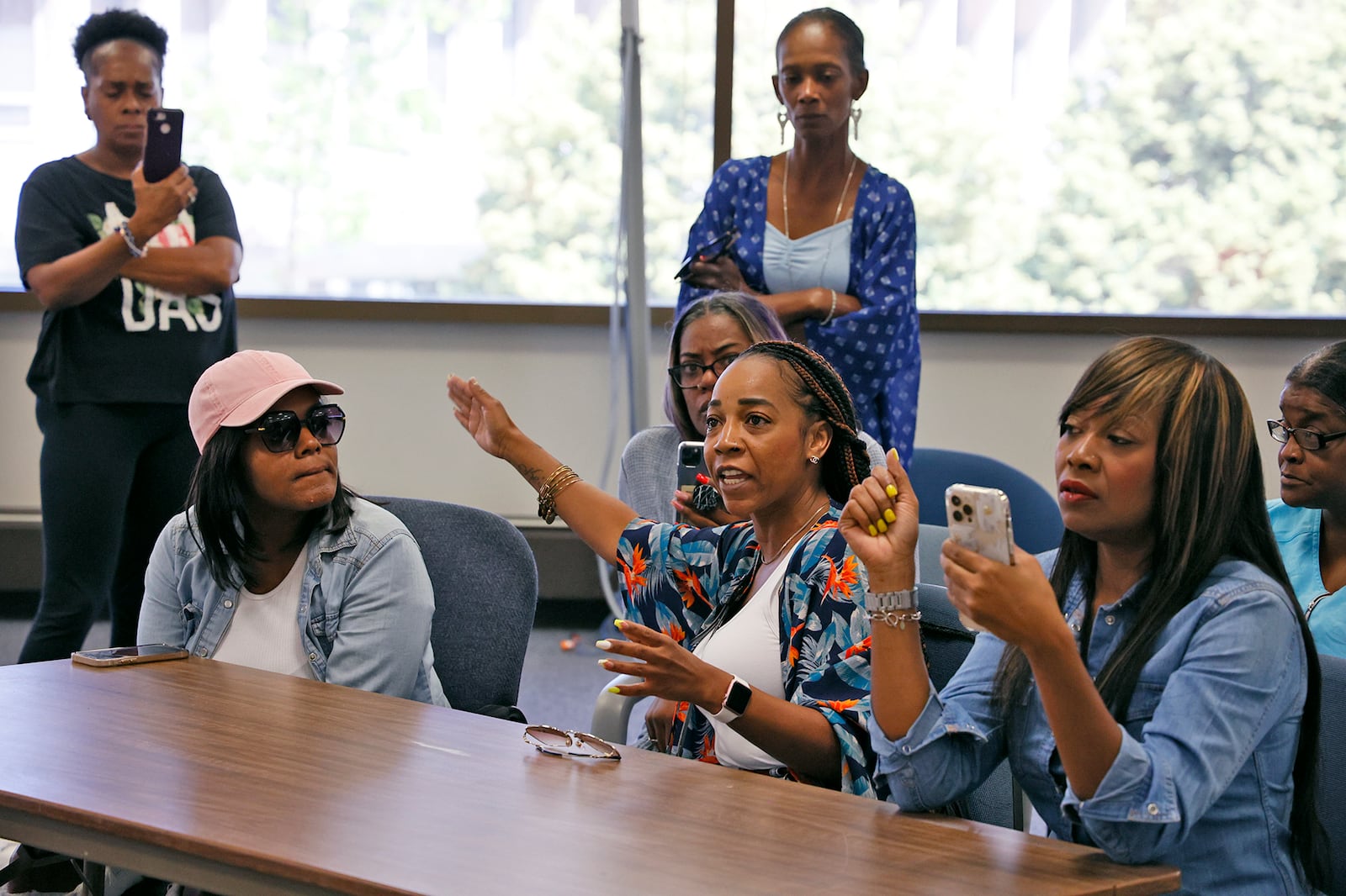 Lekeisha Bradford, the younger sister of Eric Cole, asks questions about Eric's death during a press conference Wednesday. BILL LACKEY/STAFF