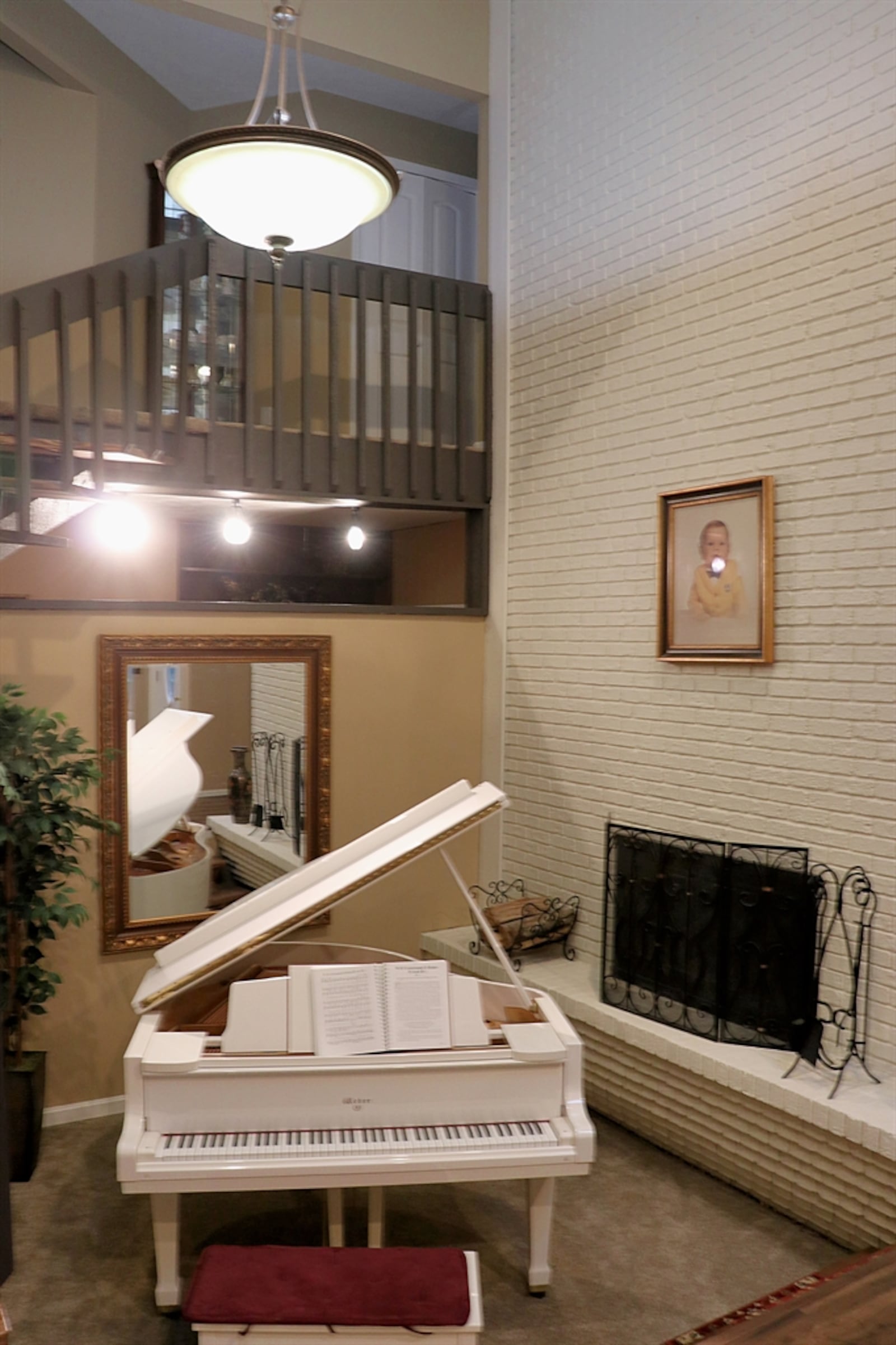 The space is used for a music room as the floating staircase wraps around up to the balcony hallway and bedroom level.  Contributed by Kathy Tyler 