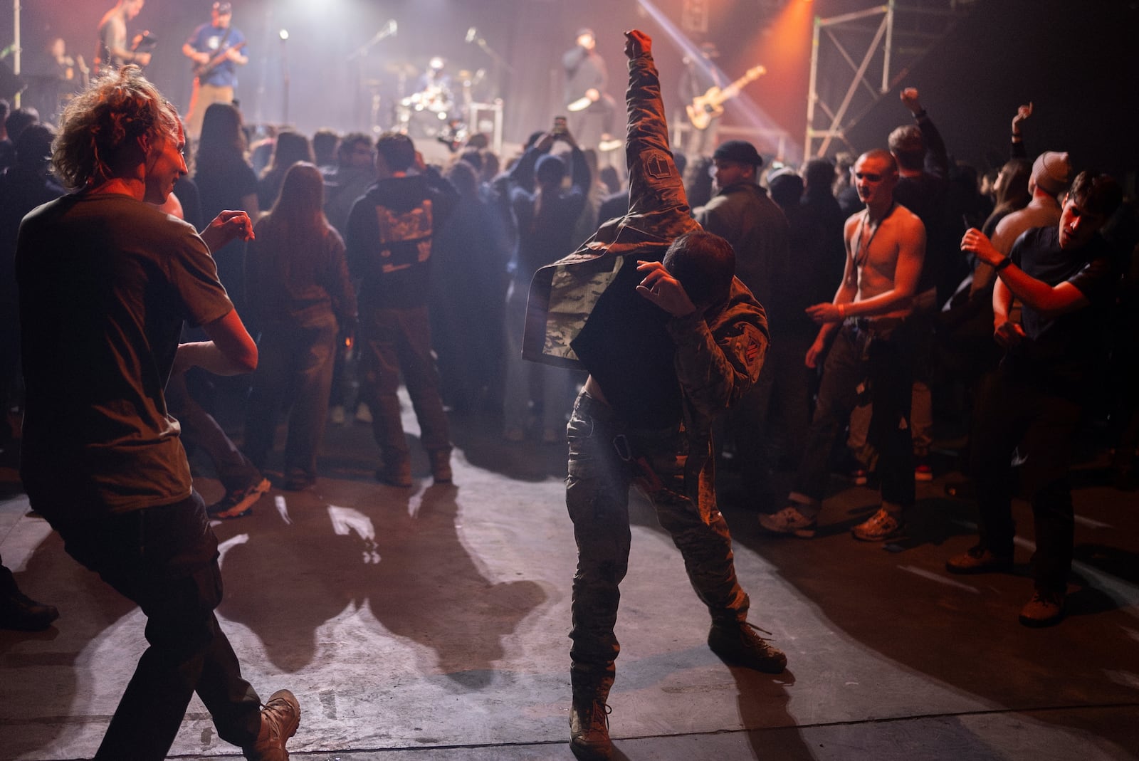 Ukrainian serviceman dance during the presentation of the music album Epoch, a collaboration between Ukrainian artists and the 3rd Assault Brigade, in Kyiv, Ukraine, Saturday, Dec. 7, 2024. (AP Photo/Alex Babenko)