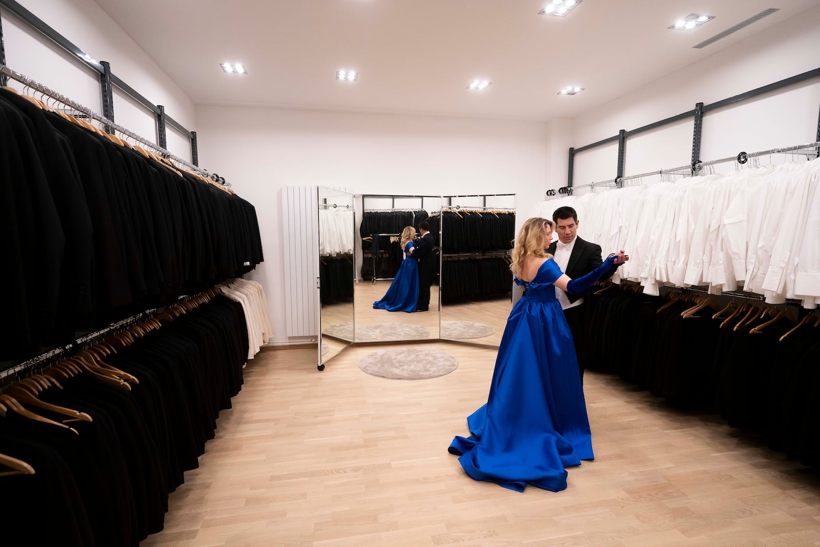 A young couple dance in the fitting room of Lambert Hofer, a renowned costume workshop in Vienna, Austria, Wednesday, Febr 26, 2025. (AP Photo/Denes Erdos)