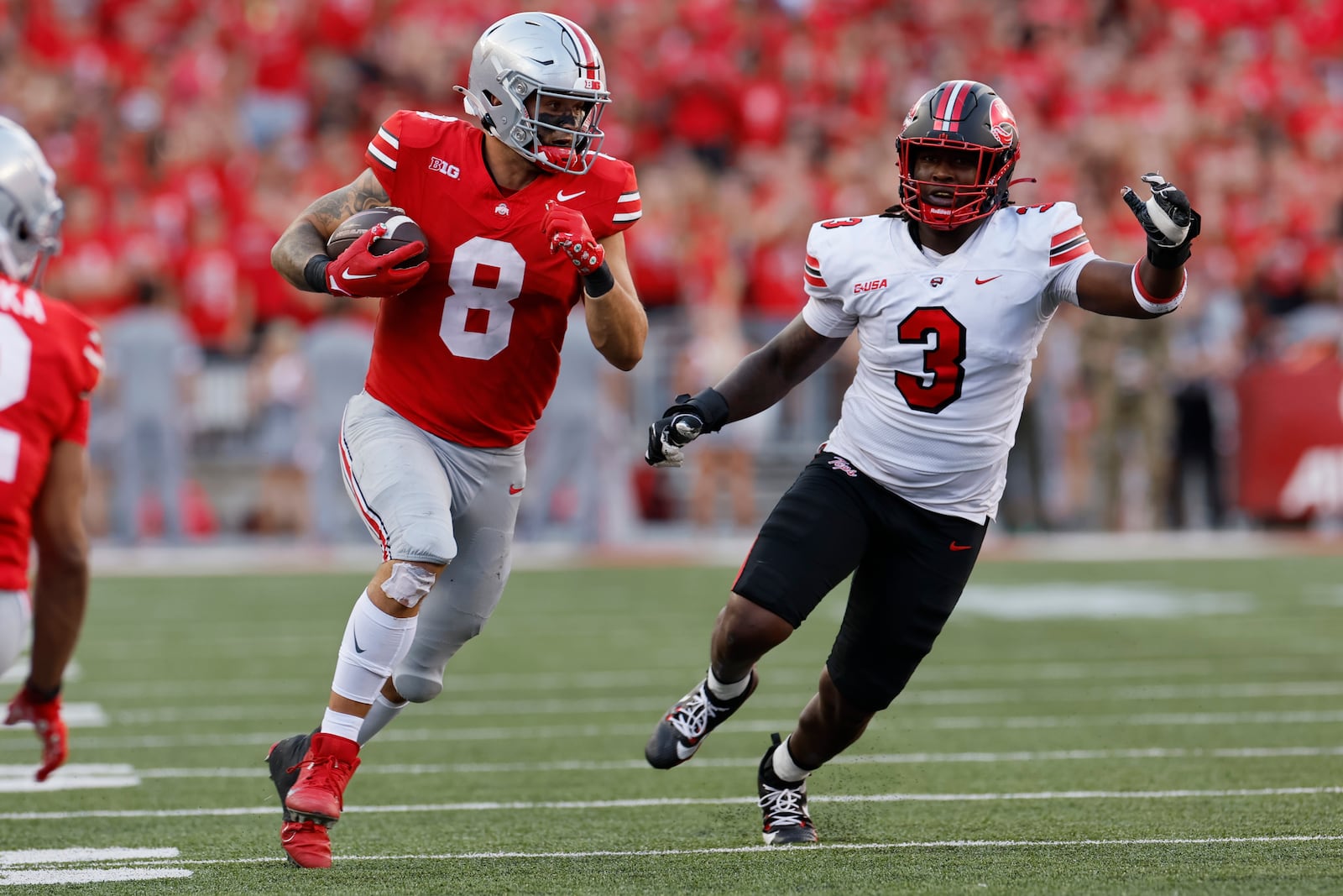 Ohio State tight end Cade Stover, left, turns up field past Western Kentucky linebacker JaQues Evans during the first half of an NCAA college football game, Saturday, Sept. 16, 2023, in Columbus, Ohio. (AP Photo/Jay LaPrete)