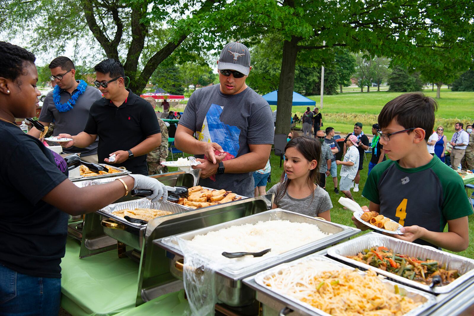 Participants select from a buffet at a luau May 27, sponsored by the Wright-Patterson Air Force Base Asian-American Pacific Islander Association. Free food and dance performances were available for those who wanted them outside the USO on Wright-Patterson Air Force Base. U.S. AIR FORCE PHOTO/R.J. ORIEZ