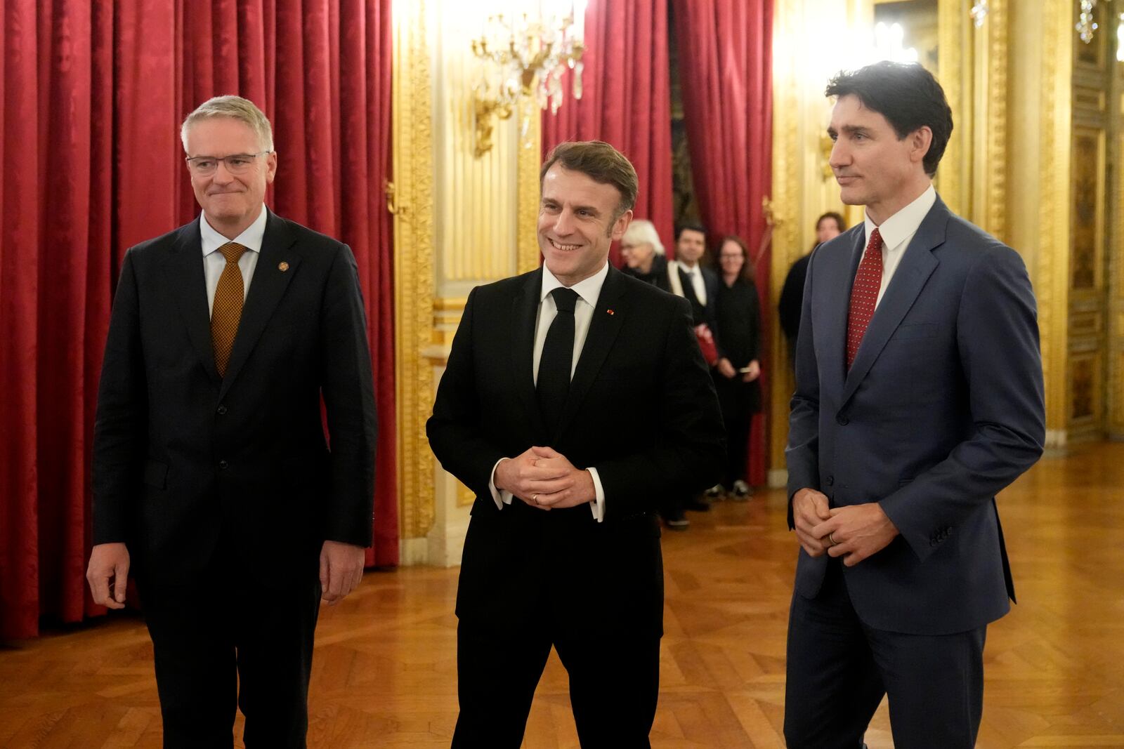 French President Emmanuel Macron, center, Canada's Prime Minister Justin Trudeau, right, and Secretary General of the OECD Mathias Cormann at the French Foreign Ministry ahead of the AI Action Summit in Paris, Sunday, Feb. 9, 2025. (AP Photo/Michel Euler, Pool)