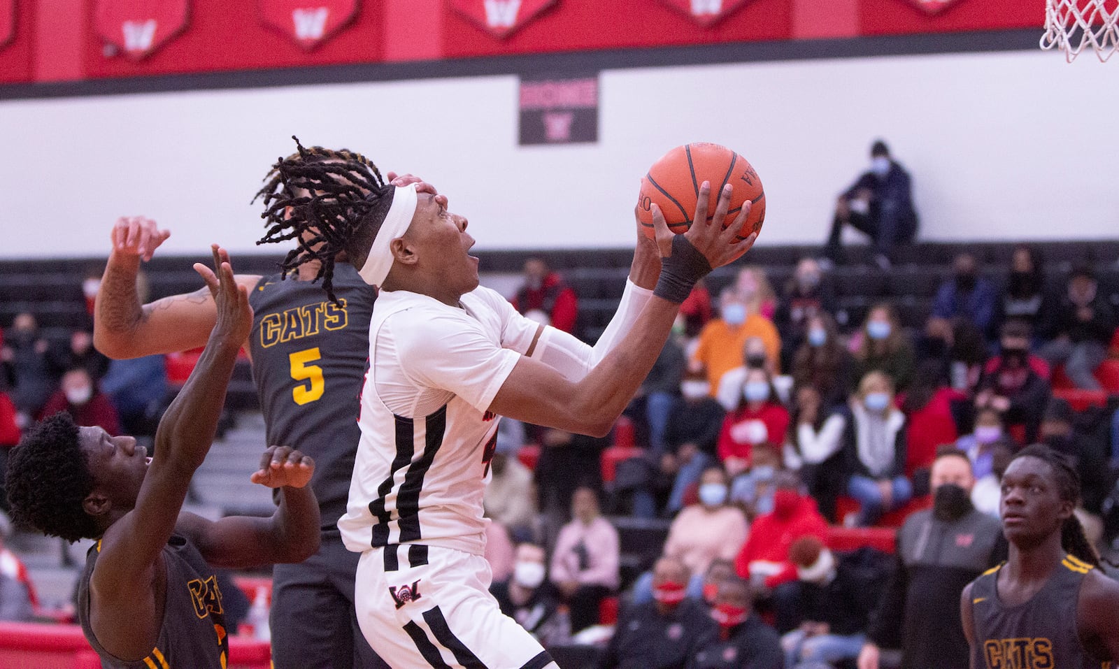 Wayne senior Prophet Johnson goes to the basket against Springfield's Josh Tolliver during the second half of Springfield's 59-57 victory Friday night. Johnson led all scorers with 23 points. Jeff Gilbert/CONTRIBUTED