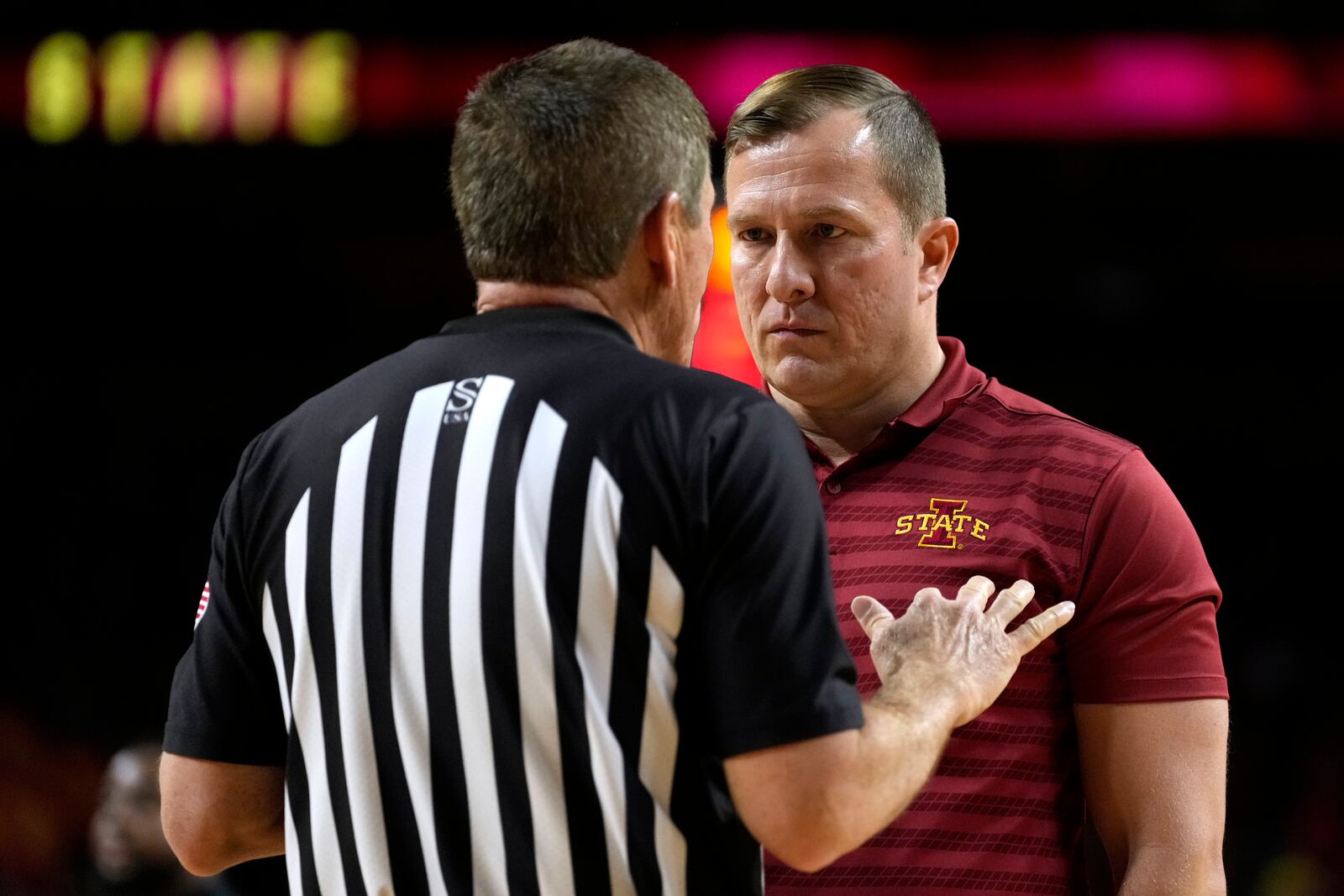 Iowa State head coach T.J. Otzelberger, right, talks with an official at the end of the first half of an NCAA college basketball game against Cincinnati Saturday, Feb. 15, 2025, in Ames, Iowa. (AP Photo/Charlie Neibergall)