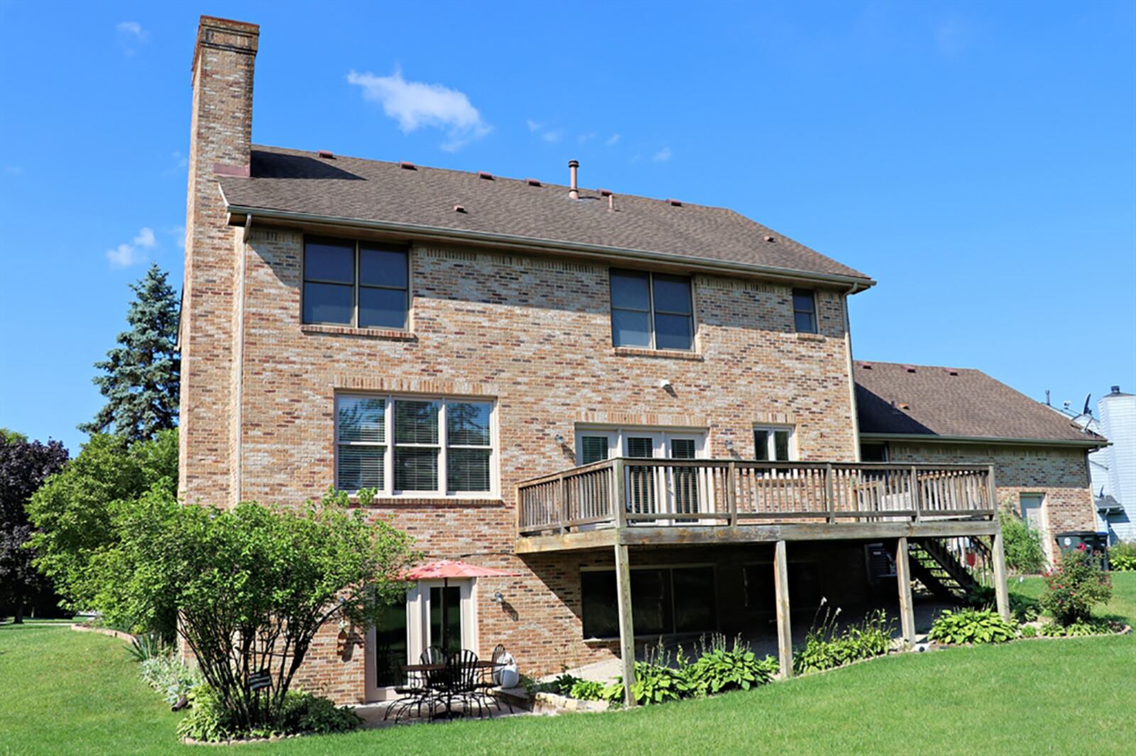 Triple patio doors open from the breakfast room to a balcony wooden deck that has steps to the back yard. CONTRIBUTED PHOTO BY KATHY TYLER