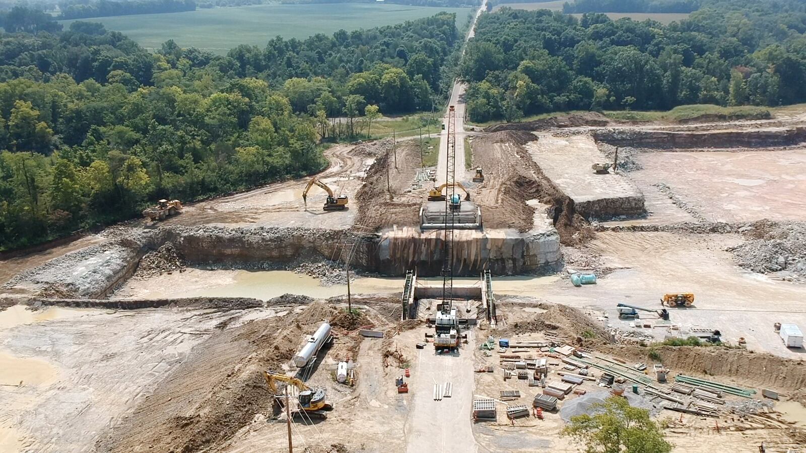 Contractors have begun to build a bridge on a stretch of State Route 235 where Fairborn Cement Compnay has quarried limestone through the right of way to the east side of the road.  The bridge will allow cement workers to drive under the state route to continue quarry work without crossing the road.  The project work began in April and is expected to be complete in October or November.    TY GREENLEES / STAFF