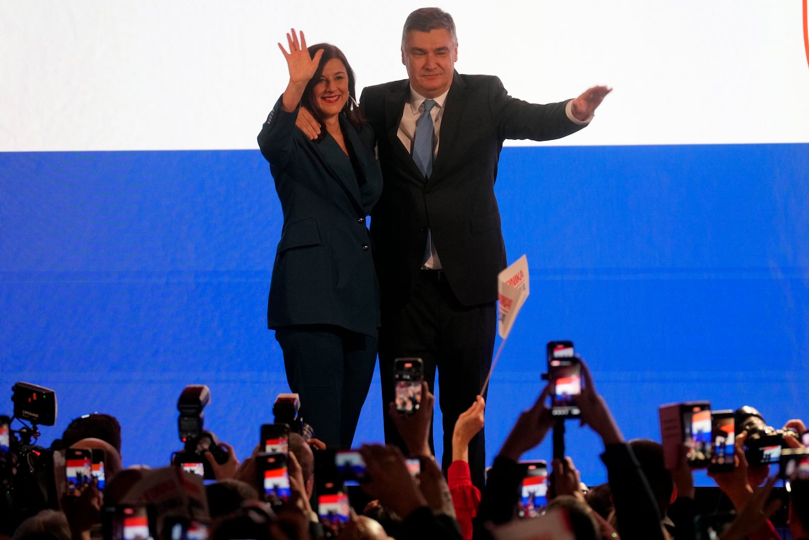 President incumbent Zoran Milanovic with his wife Sanja Music Milanovic arrives to greet supporters as the preliminary results grant him victory in a runoff vote for the Croatian presidential election in Zagreb, Croatia, Sunday, Jan. 12, 2025. (AP Photo/Darko Bandic)