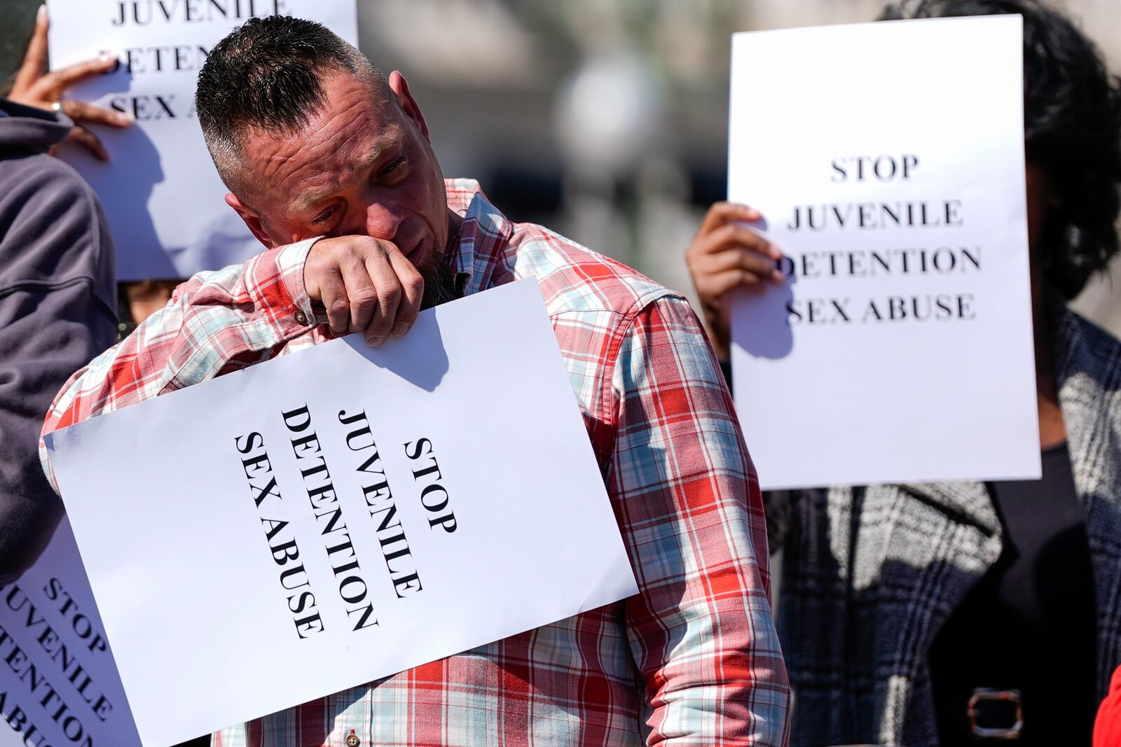 A person becomes emotional during a press conference addressing sexual abuse in Maryland juvenile detention centers, Wednesday, March 19, 2025, in Baltimore. (AP Photo/Stephanie Scarbrough)