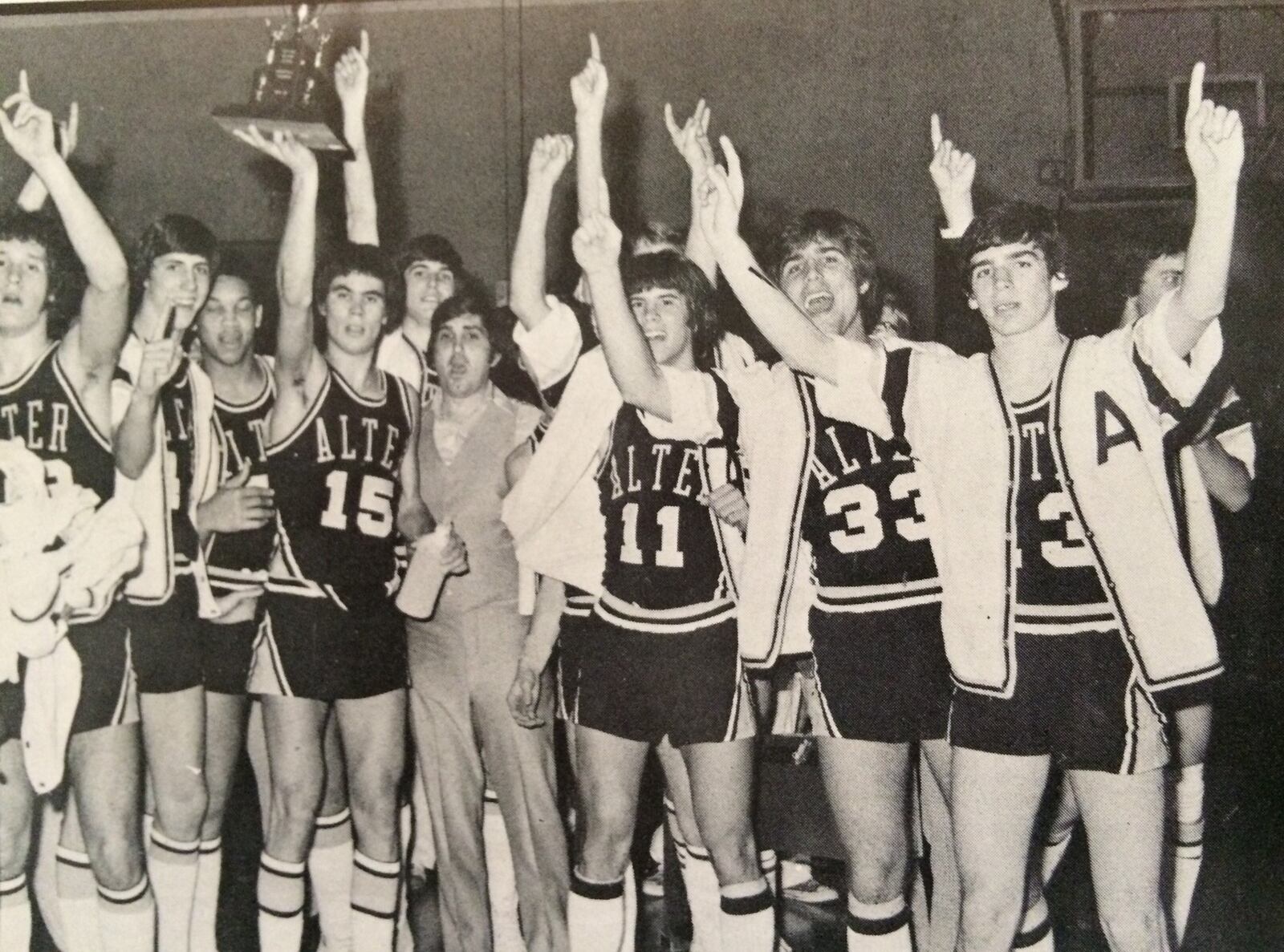 The 1975-76 Alter High basketball team included Jack Zimmerman (No. 15 ) holding up trophy up while standing next to Knights head coach Joe Petrocelli. Tim Gallagher is on the far right. CONTRIBUTED