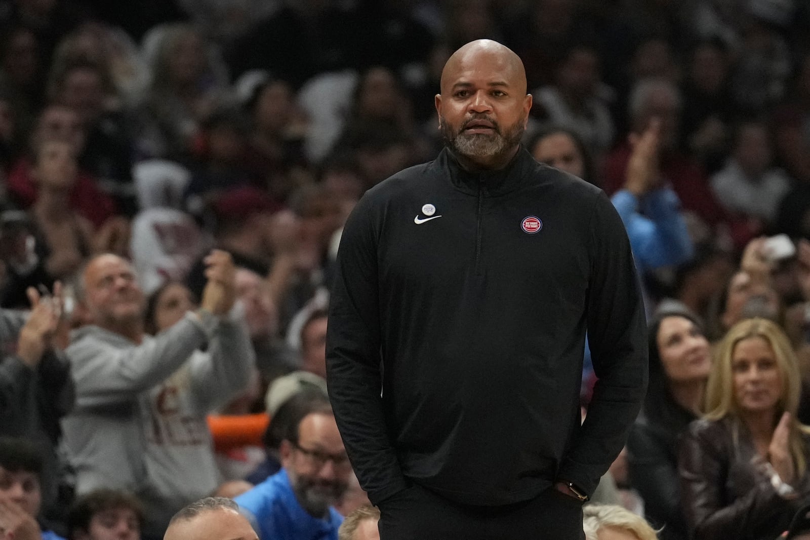 Detroit Pistons head coach J.B. Bickerstaff listens to a video tribute during a time out in the first half of an NBA basketball game against the Cleveland Cavaliers, where he coached the past five years, Friday, Oct. 25, 2024, in Cleveland. (AP Photo/Sue Ogrocki)