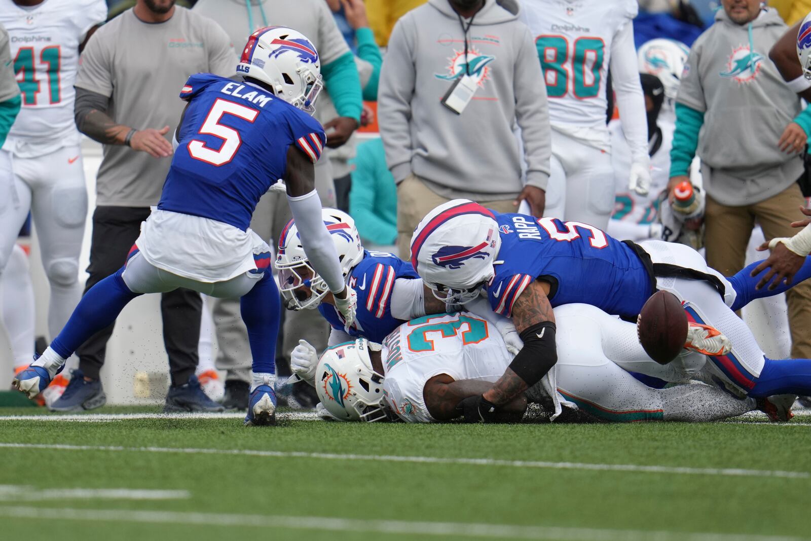 Miami Dolphins running back Raheem Mostert (31) fumbles the football as Buffalo Bills safety Taylor Rapp (9) defends during the second half of an NFL football game Sunday, Nov. 3, 2024, in Orchard Park, N.Y. (AP Photo/Gene Puskar)