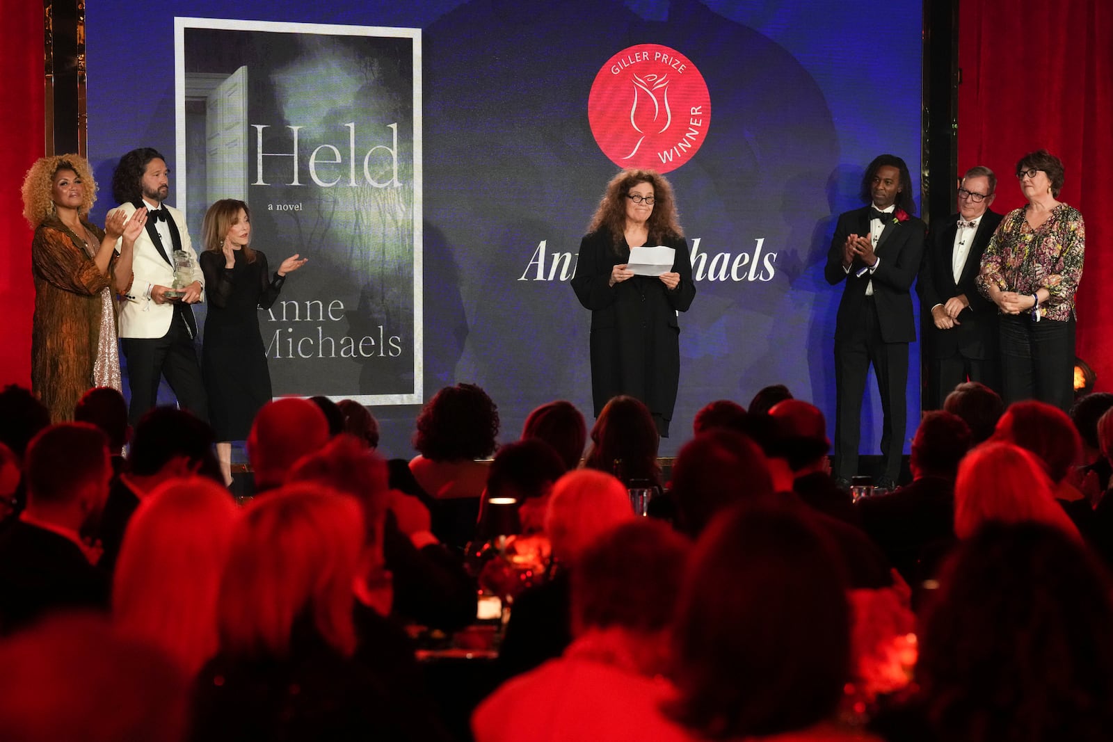 Anne Michaels accepts the Giller Prize for her book "Held" at a ceremony in Toronto, Monday, Nov. 18, 2024. (Chris Young/The Canadian Press via AP)