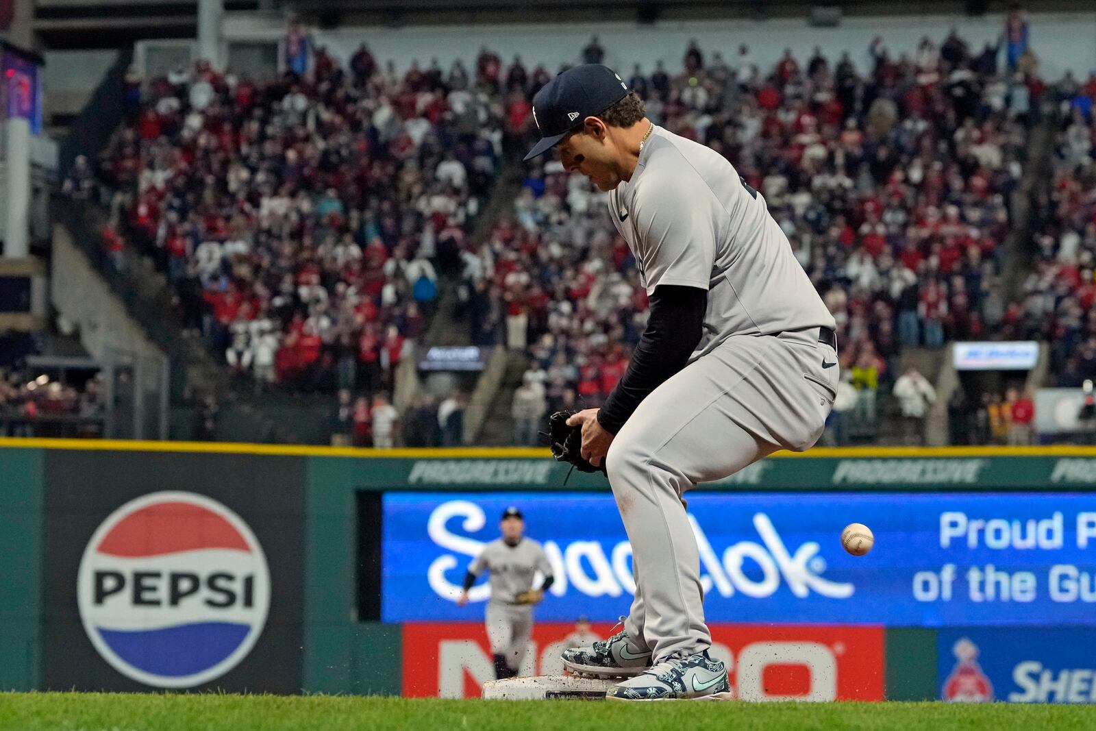 New York Yankees first baseman Anthony Rizzo tries to catch a throw from pitcher Mark Leiter Jr. during the eighth inning in Game 4 of the baseball AL Championship Series after Leiter Jr. fielded an infield hit by Cleveland Guardians' David Fry Friday, Oct. 18, 2024, in Cleveland. (AP Photo/Godofredo A. Vasquez)