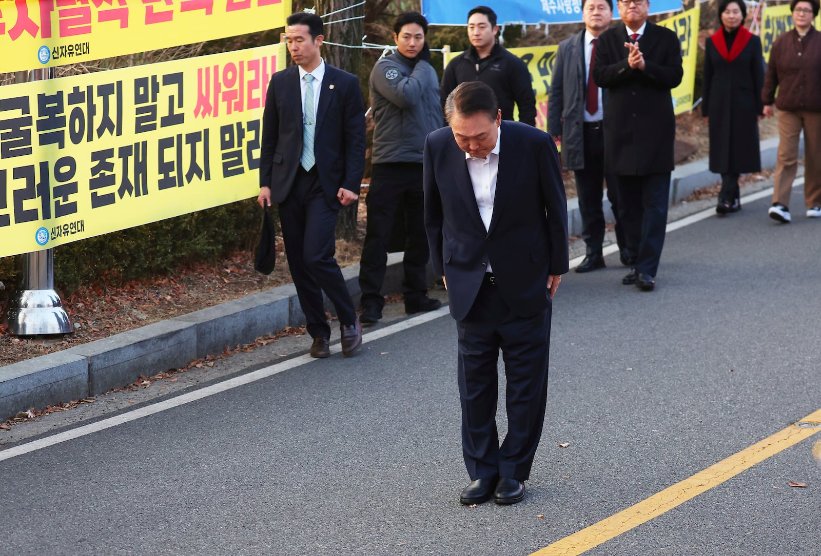 Impeached South Korean President Yoon Suk Yeol greets to his supporters after he came out of a detention center in Uiwang, South Korea, Saturday, March 8, 2025. (Kim Do-hun/Yonhap via AP)