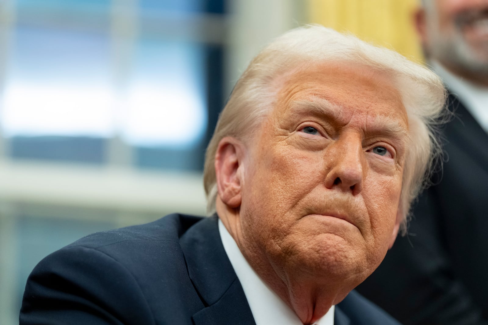 FILE - President Donald Trump speaks with reporters as he signs executive orders in the Oval Office at the White House, Monday, Feb. 10, 2025, in Washington. (AP Photo/Alex Brandon, file)