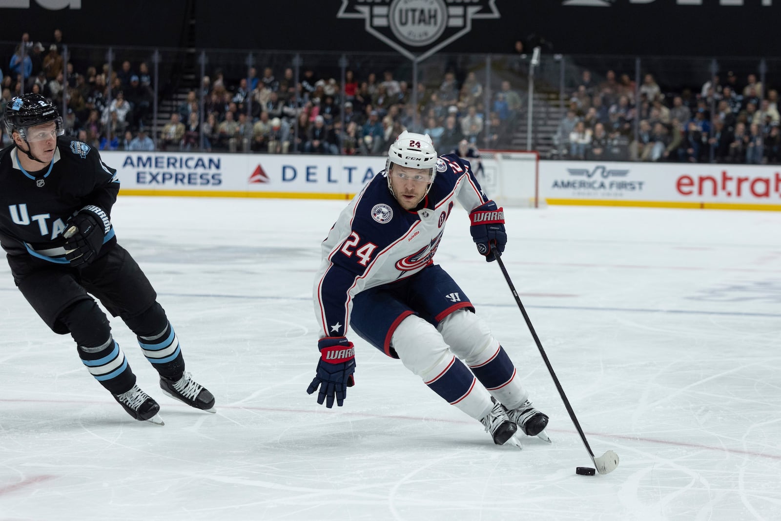 Columbus Blue Jackets right wing Mathieu Olivier (24) skates with the puck against Utah Hockey Club defenseman Olli Maatta (2) during the second period of an NHL hockey game Friday, Jan. 31, 2025, in Salt Lake City. (AP Photo/Melissa Majchrzak)