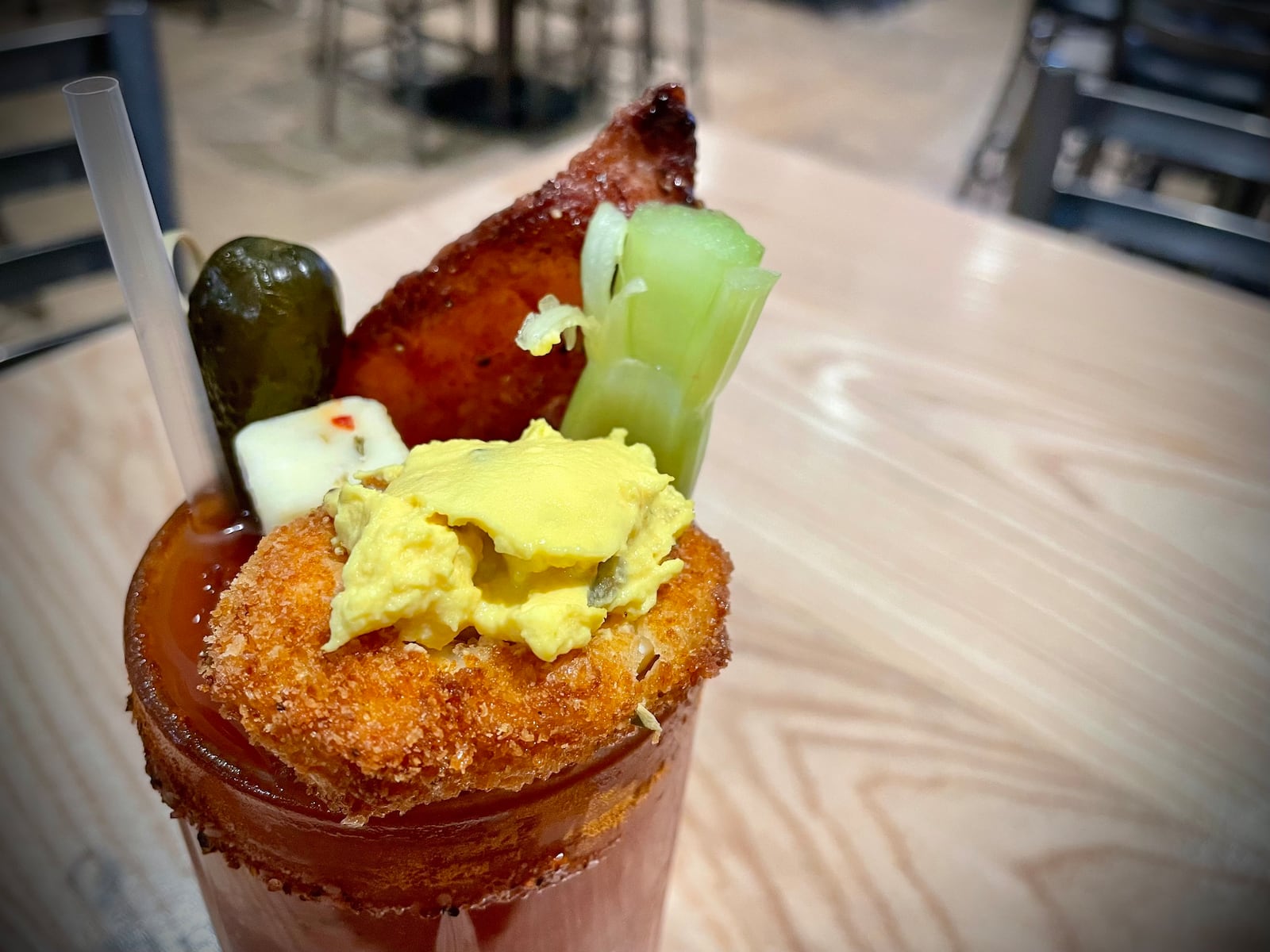 Loose Ends Brewing Company is located at 890 S. Main St. in Centerville. Pictured is the brewery's Bloody Mary featuring The Bloody Mary included a bacon salt rim, sweet heat candied bacon, a deep-fried deviled egg, sweet gherkin, pepper jack cheese, celery and lime. NATALIE JONES/STAFF