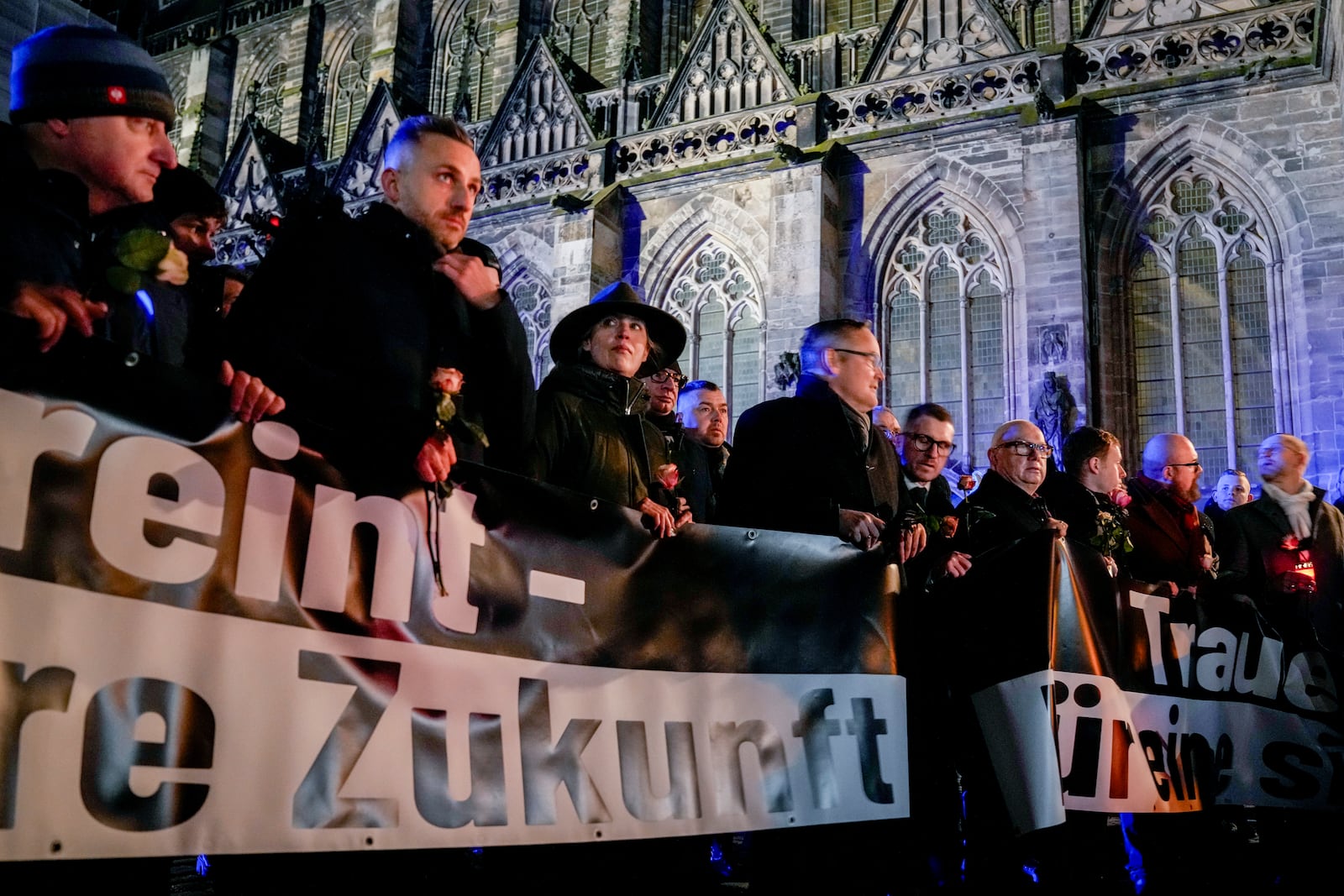 Co leader of German far right party AfD Alice Weidel, 3rd from left, attends an AfD election campaign in front of the cathedral in Magdeburg, Germany, Monday, Dec. 23, 2024. (AP Photo/Ebrahim Noroozi)