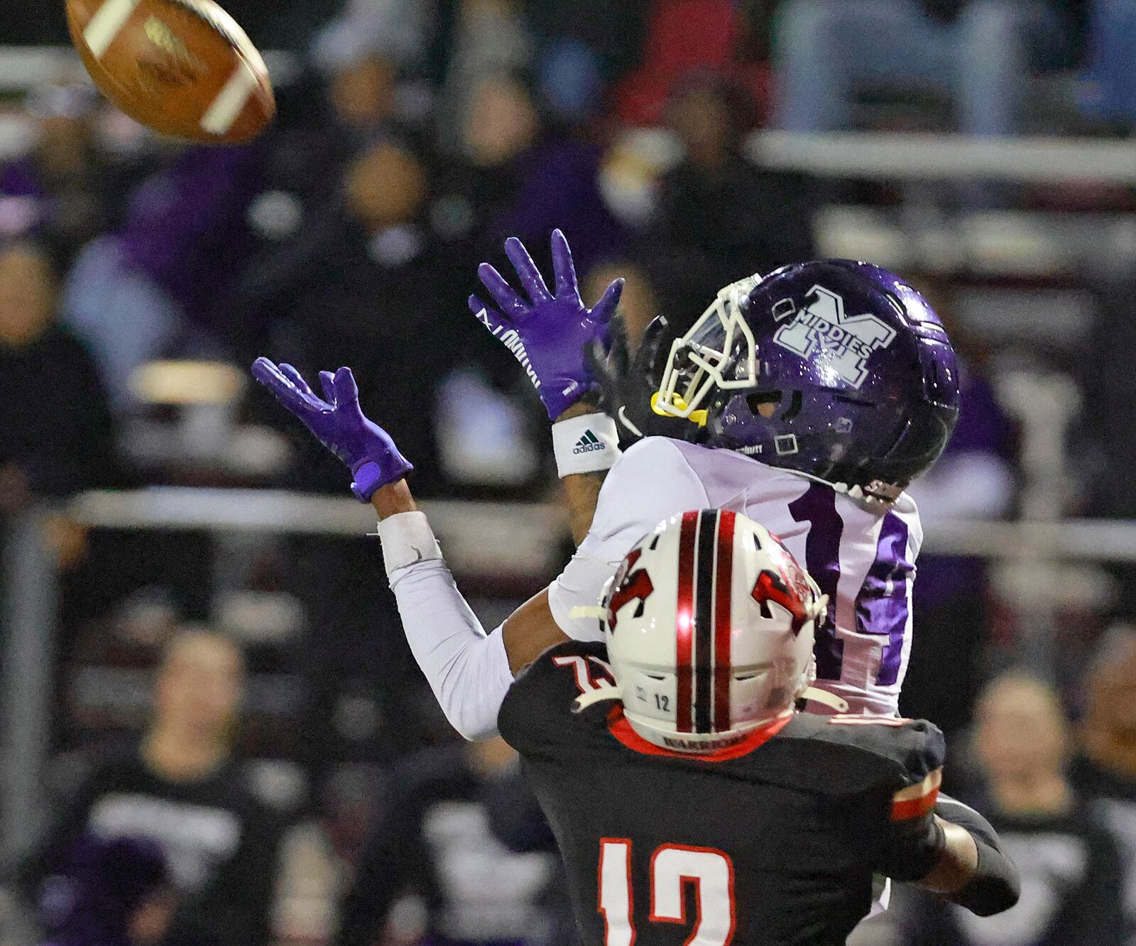 Middletown's Chandler Shields catches a pass under pressure from Wayne's Sean Westmoreland during Friday's playoff game. BILL LACKEY/STAFF