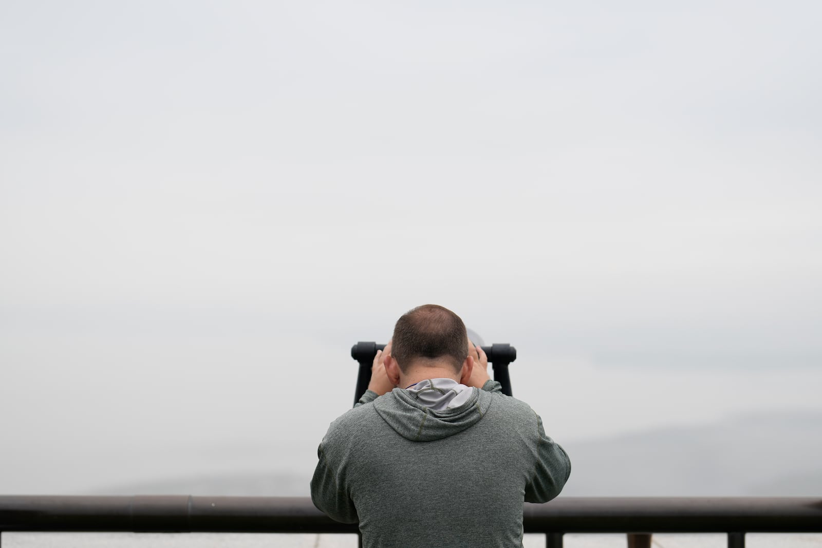 A visitor uses binoculars to see the North Korean side from the unification observatory in Paju, South Korea, Tuesday, Oct. 15, 2024. (AP Photo/Lee Jin-man)