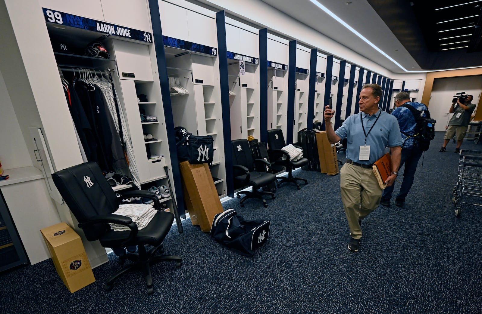 Members of the media look around the New York Yankees clubhouse during a tour of the upgraded team spring training facilities Thursday, Feb. 13, 2025, at George M. Steinbrenner Field in Tampa, Fla. (AP Photo/Steve Nesius)