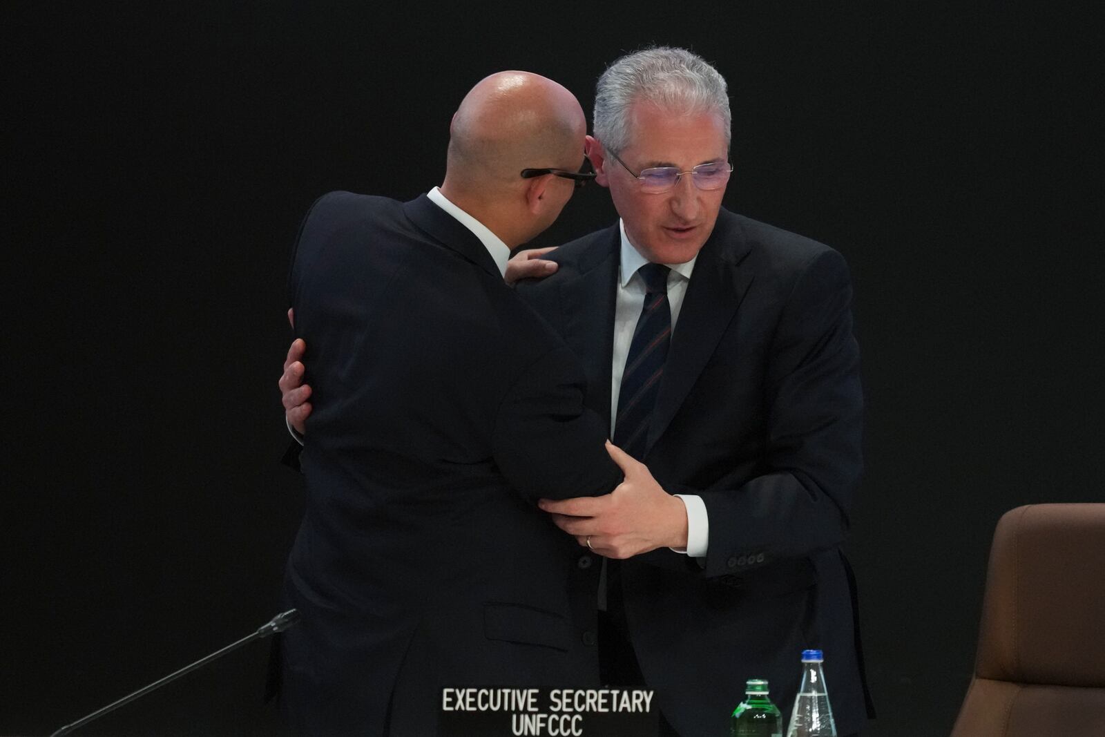 Mukhtar Babayev, COP29 President, right, and Simon Stiell, United Nations climate chief, embrace after a plenary session at the COP29 U.N. Climate Summit, Saturday, Nov. 23, 2024, in Baku, Azerbaijan. (AP Photo/Sergei Grits)