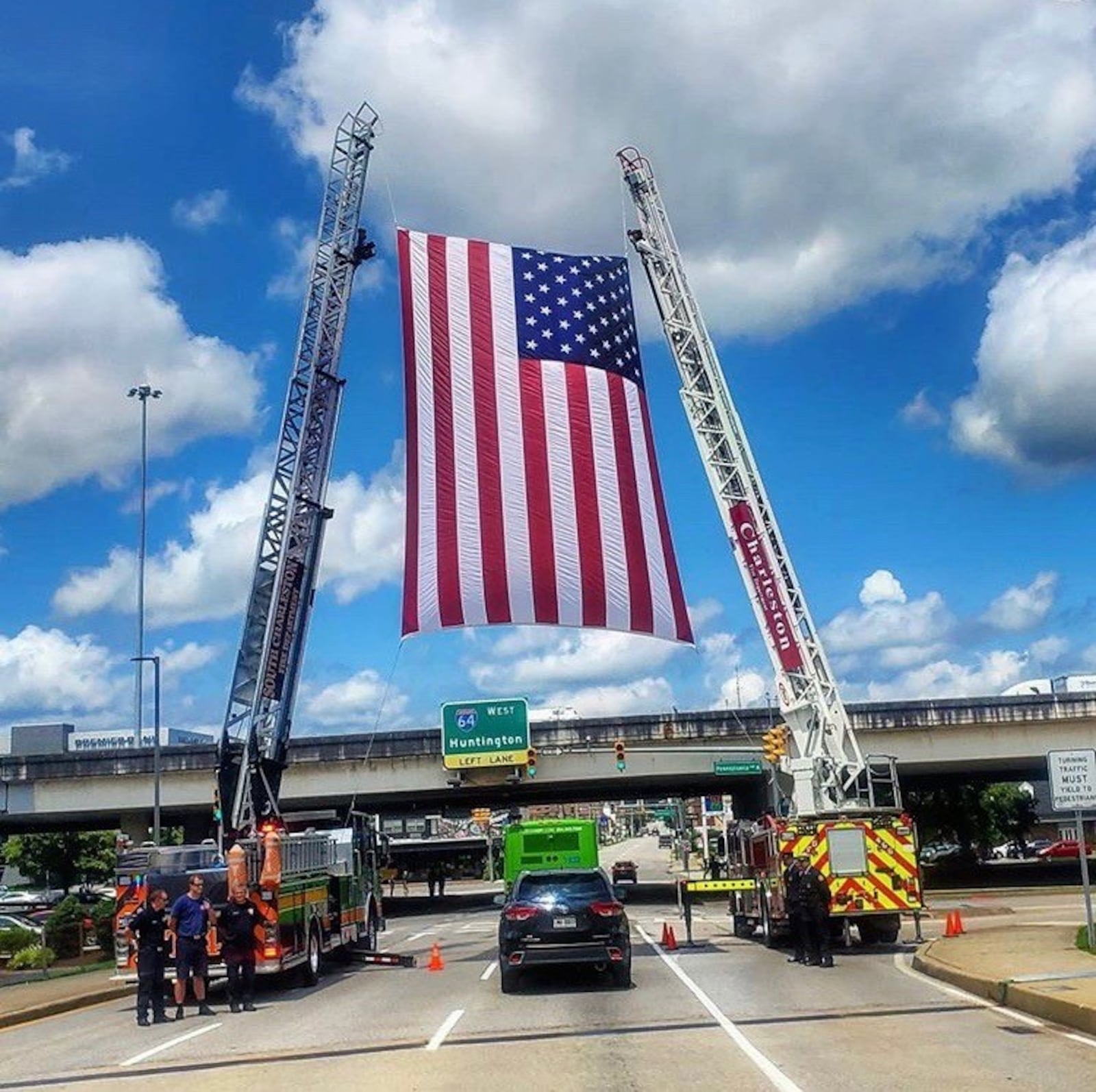 During last Friday’s citywide salute to fallen Charleston W.V. firefighter Jason Cuffee, the firetruck carrying his flag-draped coffin passed beneath a huge American flag held aloft lot by two ladder trucks on Quarrier Street. Hundreds of firefighters and medics from across the state – many in dress uniforms – showed up at the memorial ceremony held at the Charleston Coliseum and Convention Center. Many basketball players and coaches also were there, including a sizeable contingent from Cedarville University where Cuffee was a standout 6-foot-4 guard for three seasons. Cuffee died unexpectedly while in duty July 19. CONTRIBUTED