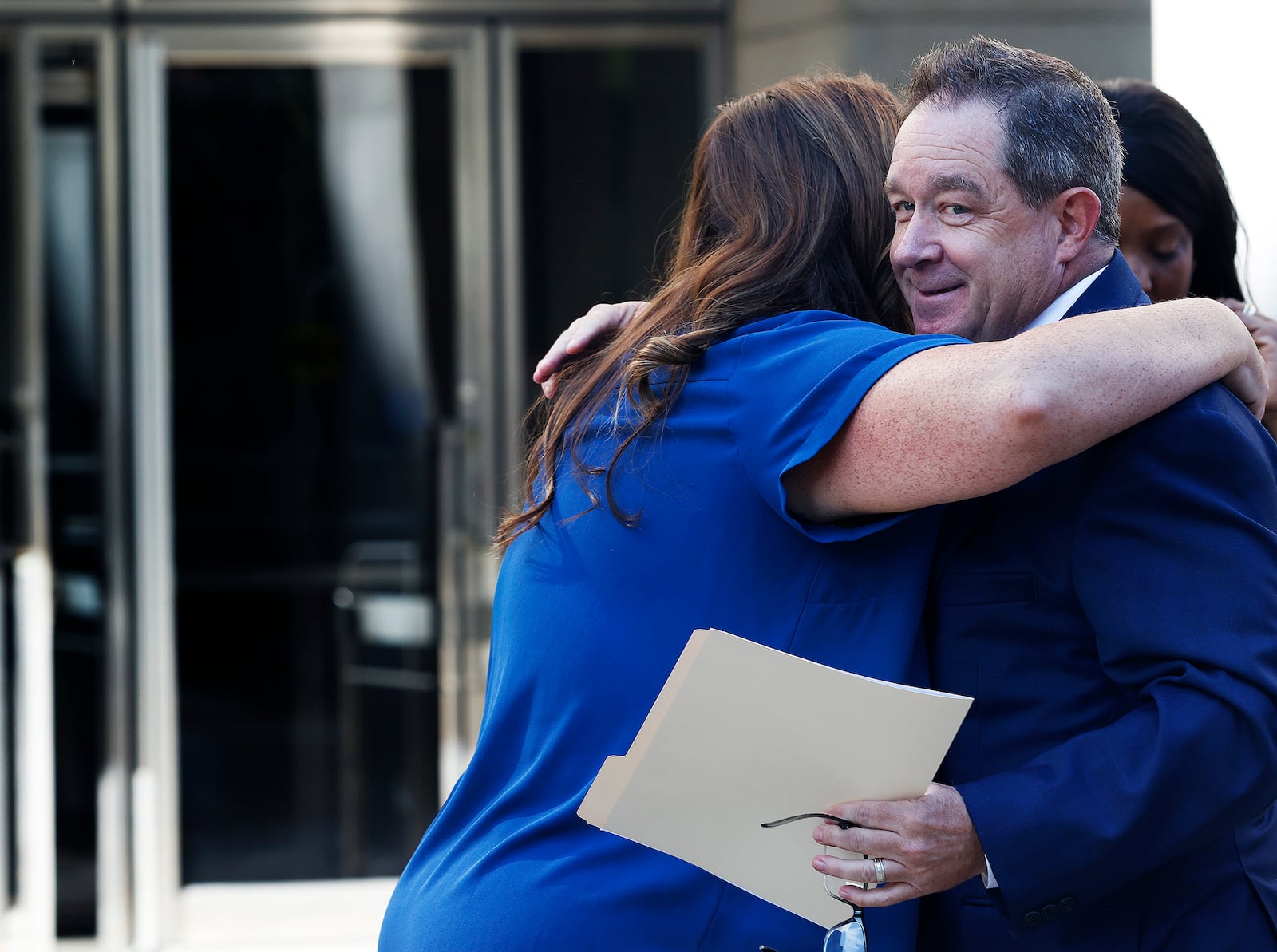 Montgomery County Clerk of Courts Mike Foley receives a hug Thursday, Sept. 12, 2024 from a staff member after his press conference at the Montgomery County Courthouse. MARSHALL GORBY\STAFF