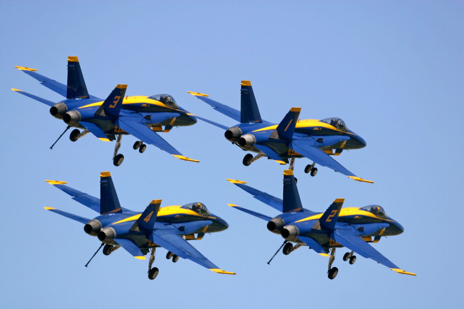 Blue Angels in the dirty diamond formation with landing gear and arresting hook lowered.