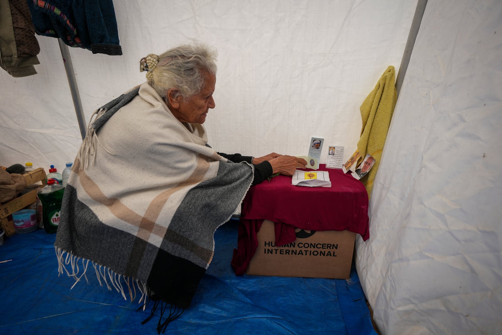 Amal Amouri sets up a little altar at the tent she and her husband Tony Al-Masri, both Christians, share at the Muwassi tent camp near Khan Younis, Gaza Strip on Christmas Day Wednesday Dec. 25, 2024.(AP Photo/Abdel Kareem Hana)