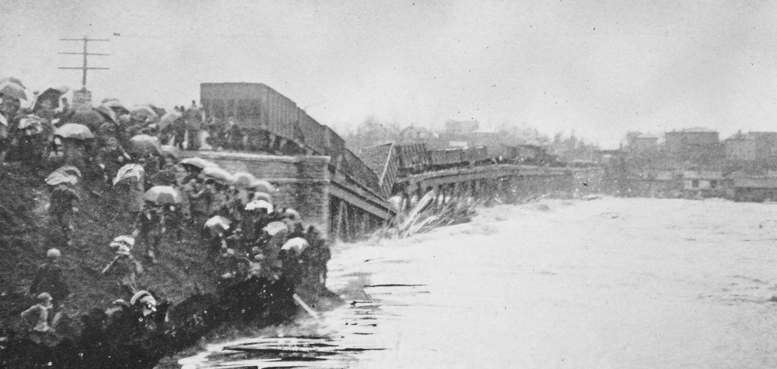 Although loaded with coal cars to stabilize the bridge from flooding, the 1893 built iron bridge would succumb to the raging 1913 flood waters. Photo courtesy of the Dan Finfrock