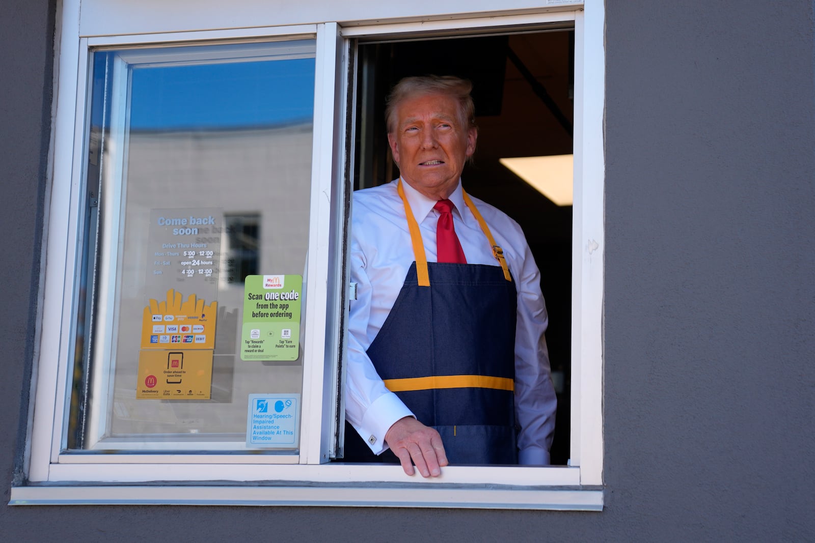 Republican presidential nominee former President Donald Trump stands at the drive-thru window during a campaign stop at a McDonald's, Sunday, Oct. 20, 2024, in Feasterville-Trevose, Pa. (AP Photo/Evan Vucci)