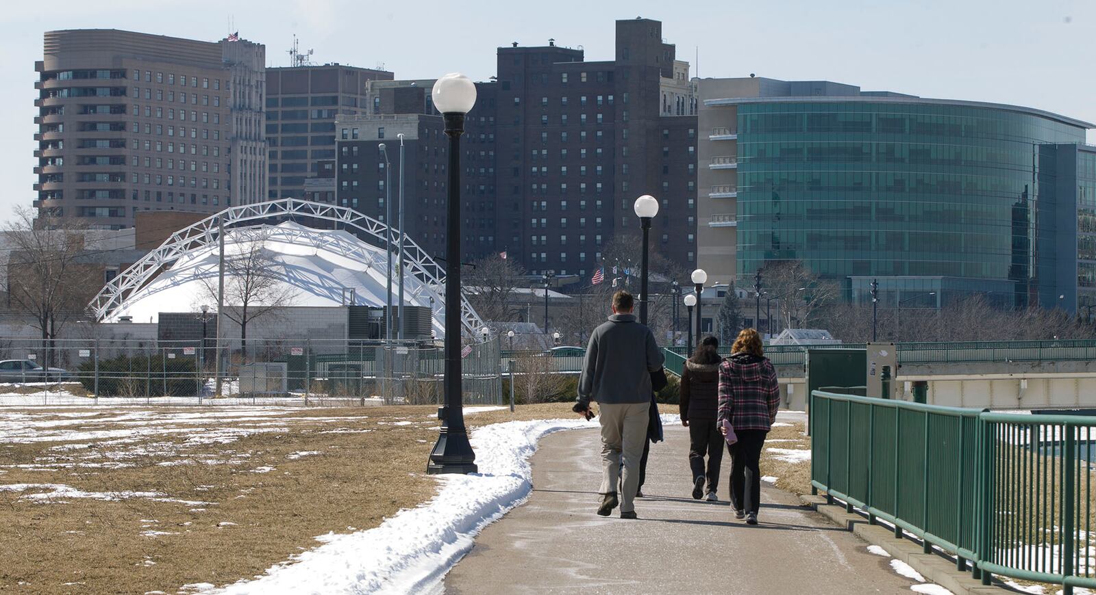 Workers from downtown Dayton walk back toward Riverscape from Deeds Point after a lunch hour walk. Staff photo by Ty Greenlees