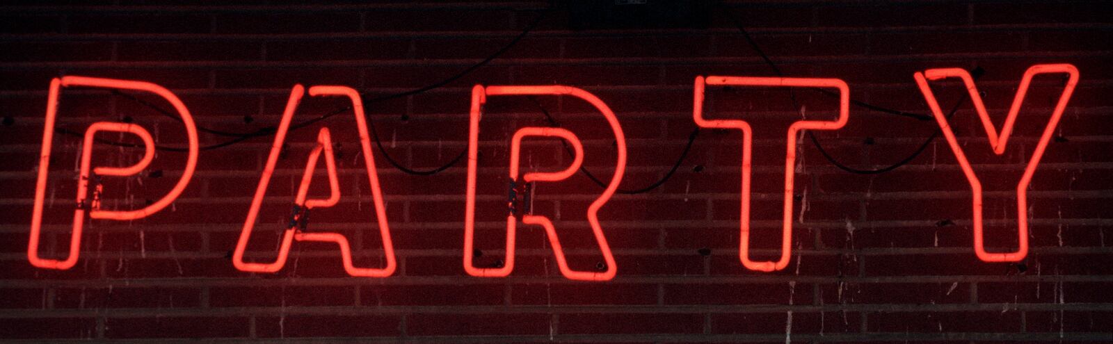 Neon Party Depot sign on South Broadway in Fairborn.   TY GREENLEES / STAFF